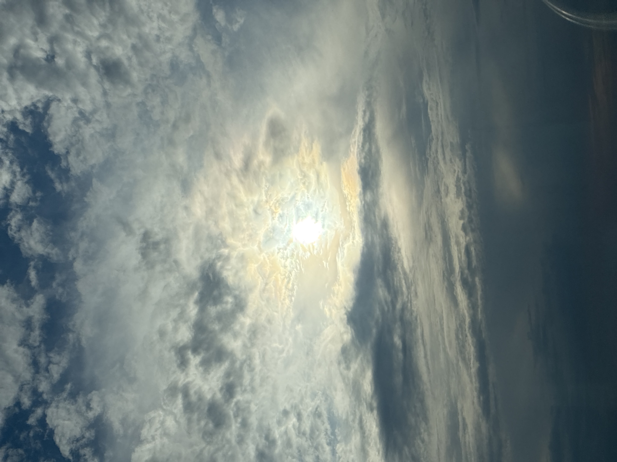 Dramatic afternoon sky with sun breaking through varied clouds