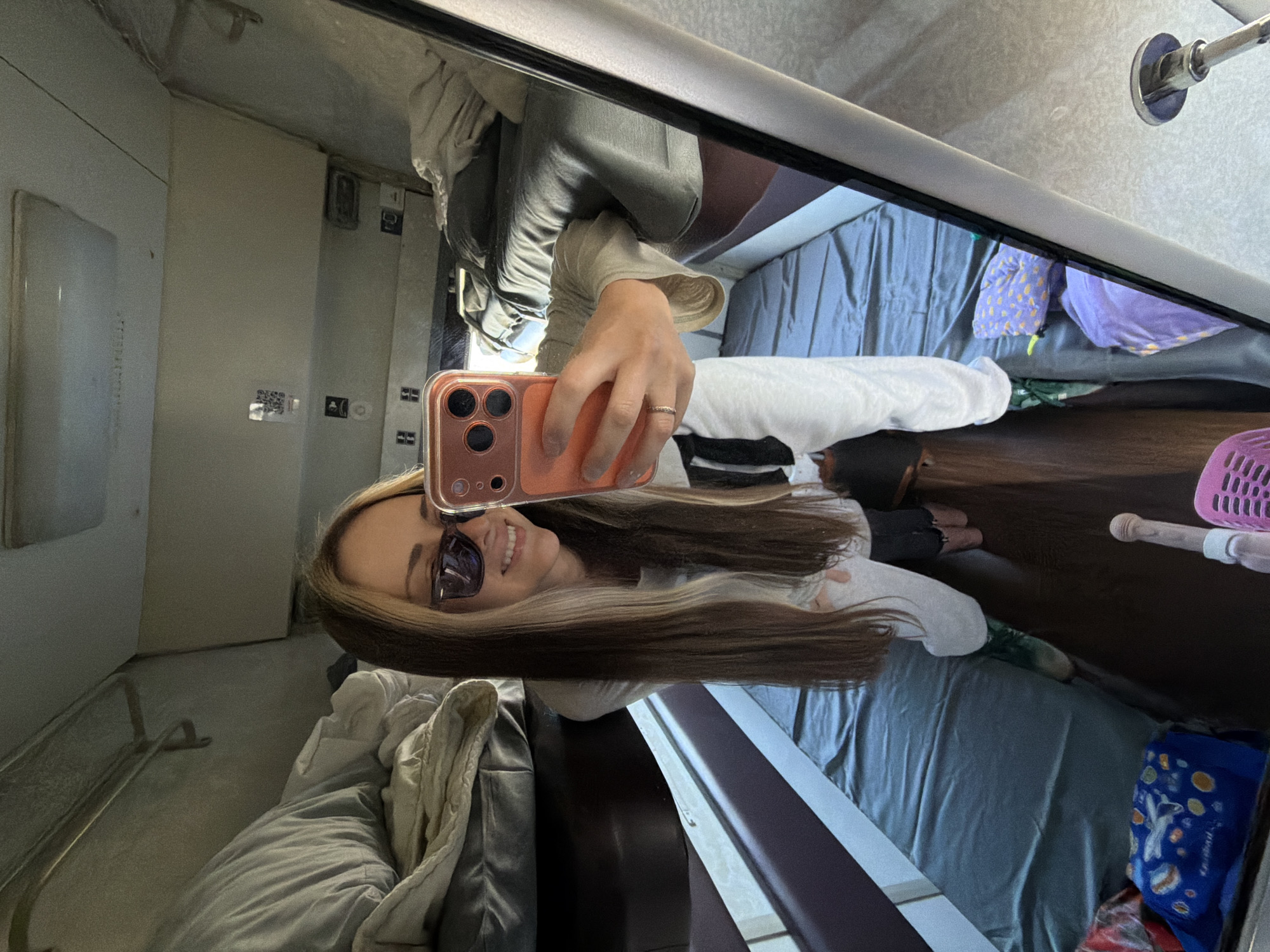 Woman takes mirror selfie in Russian train compartment