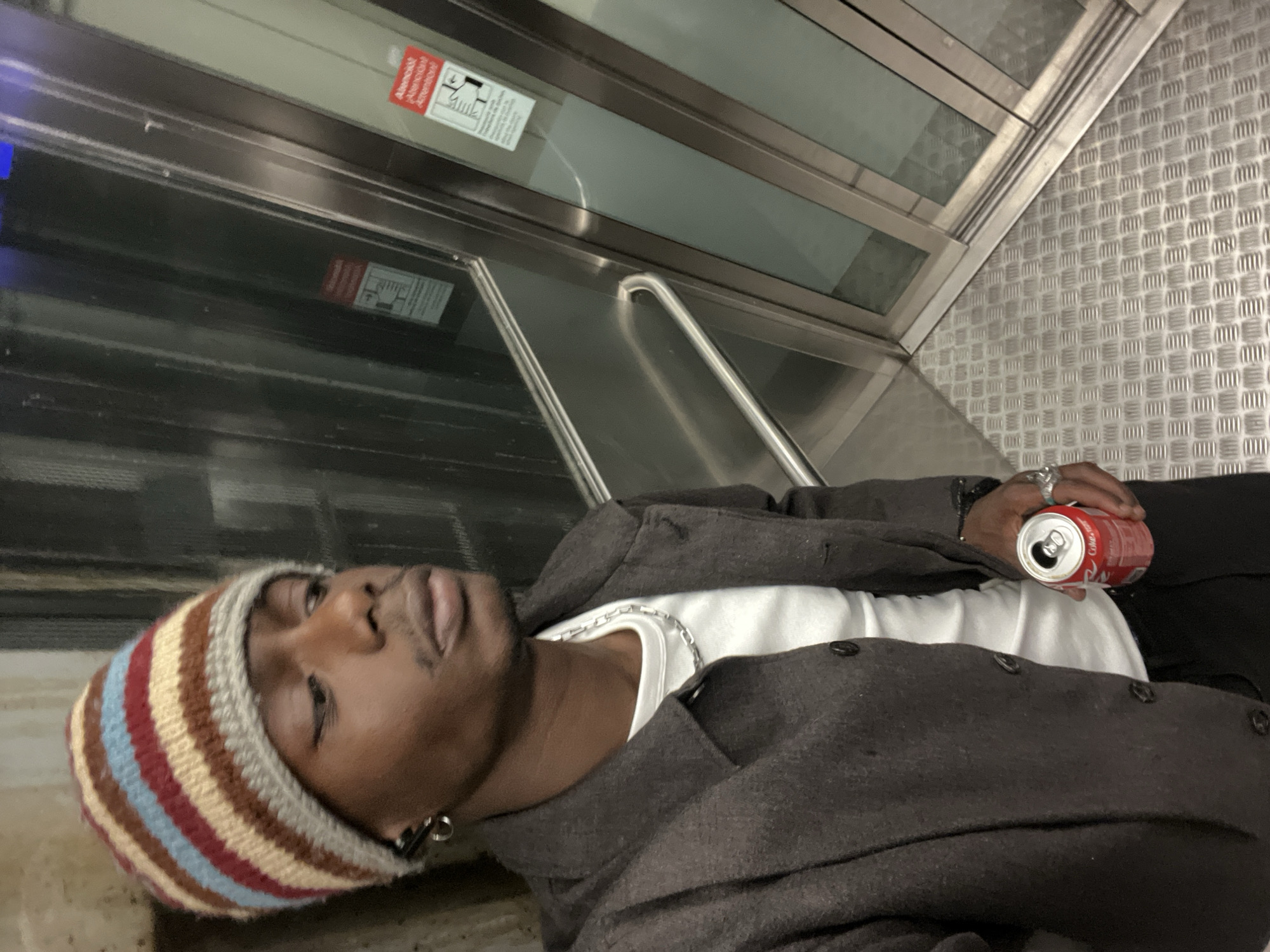 Man in striped beanie spotted across Barcelona transit locations