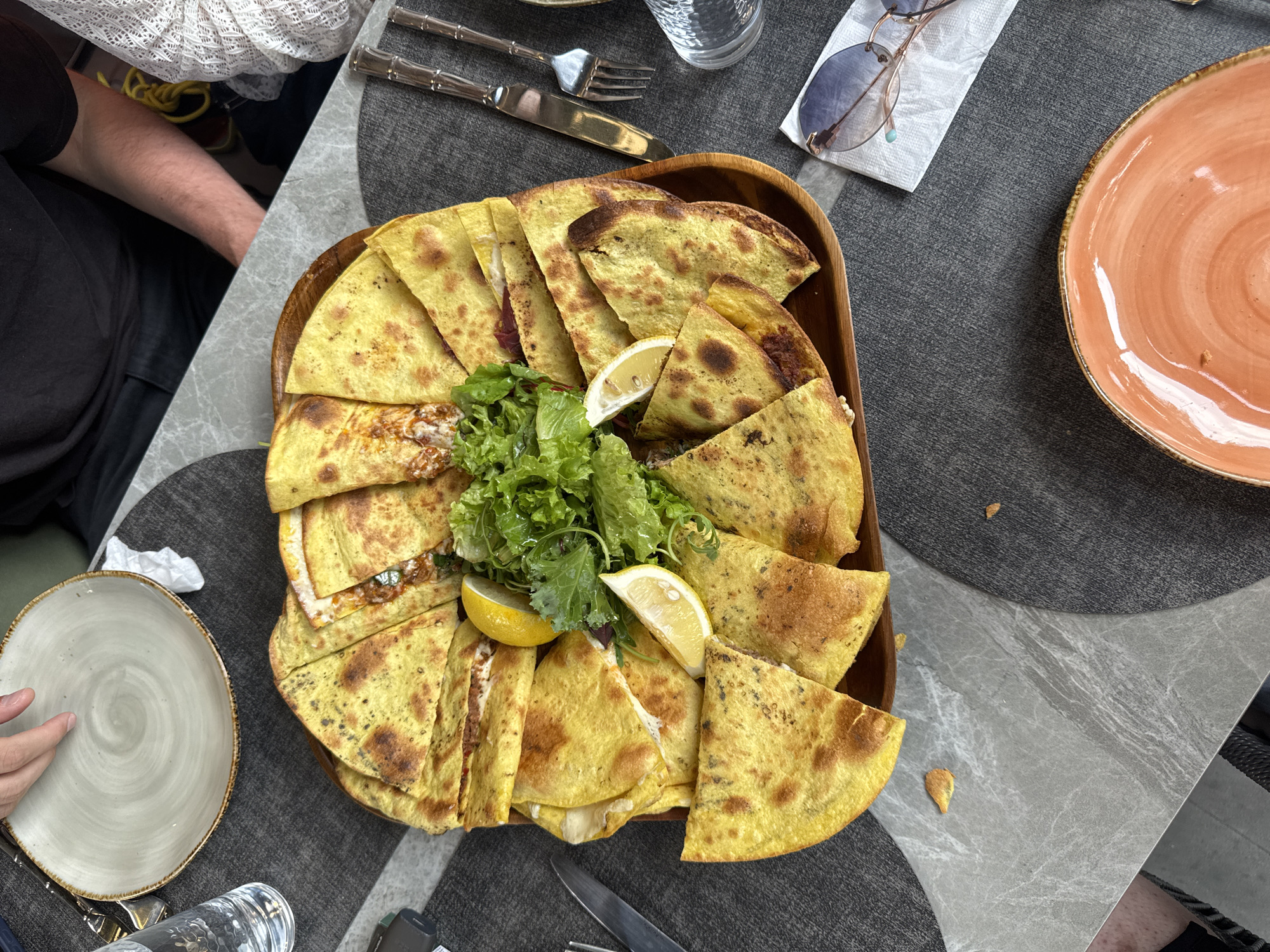 Wooden platter of folded flatbreads at a Yerevan restaurant