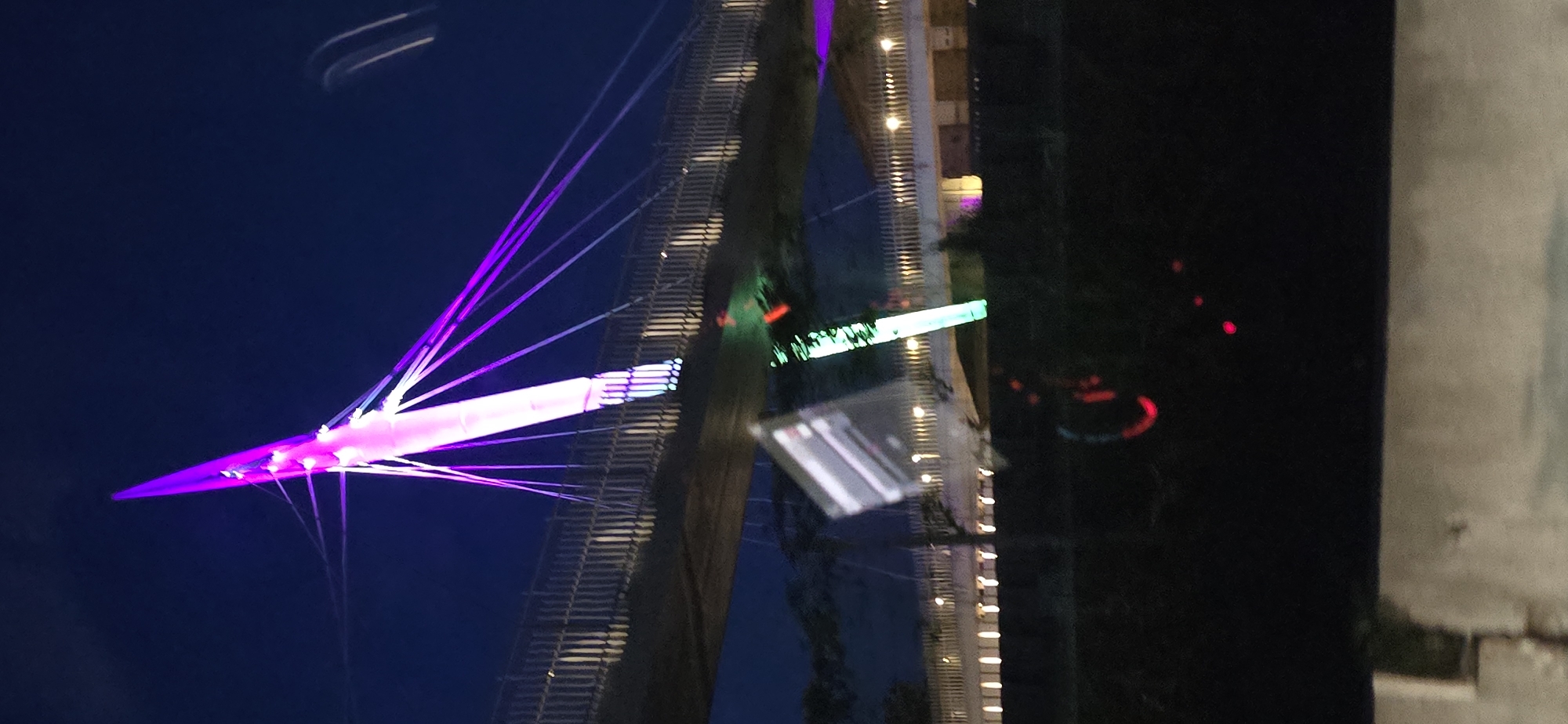 Night lights: a glowing bridge and a string-lit tree