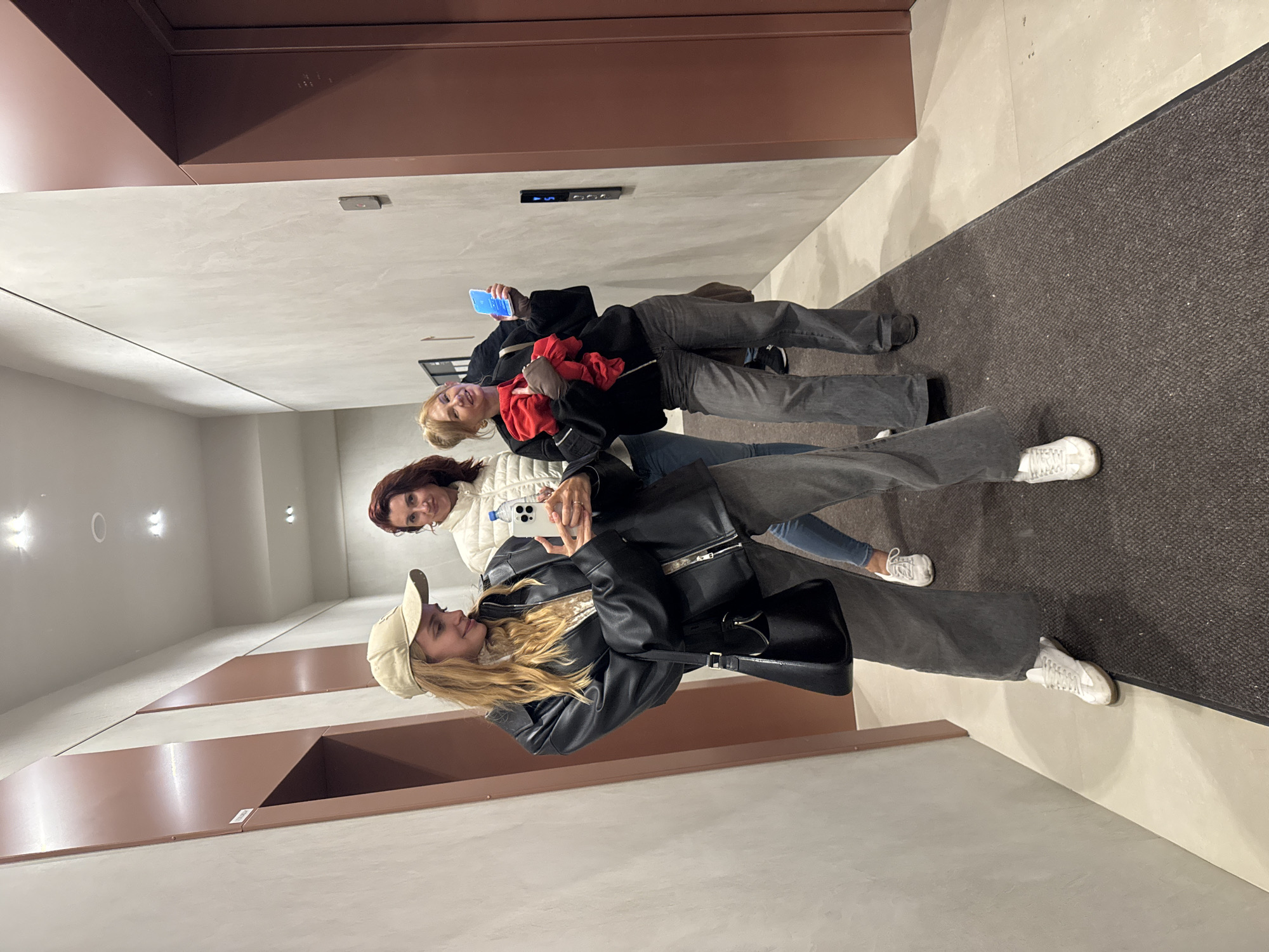 Three women take selfie in Yekaterinburg hallway