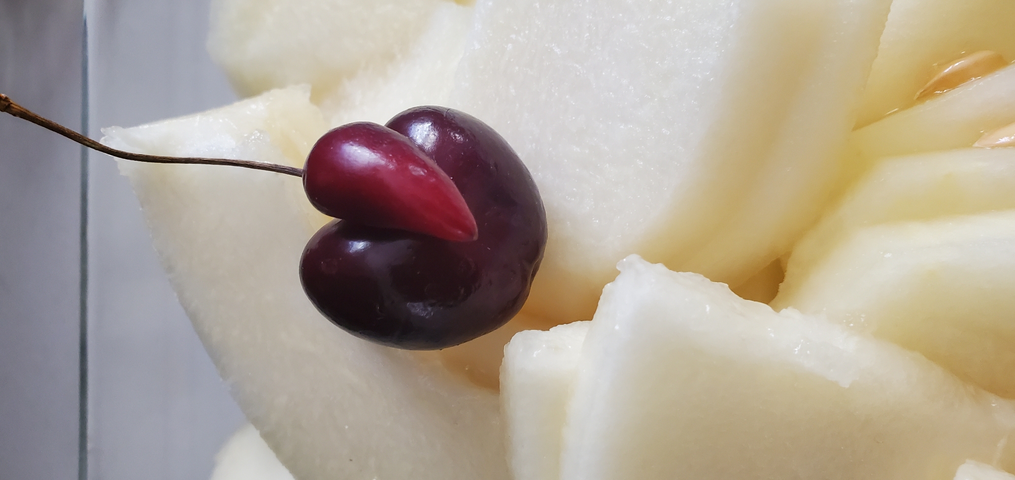 Sliced melon and a double cherry, close up in Greece