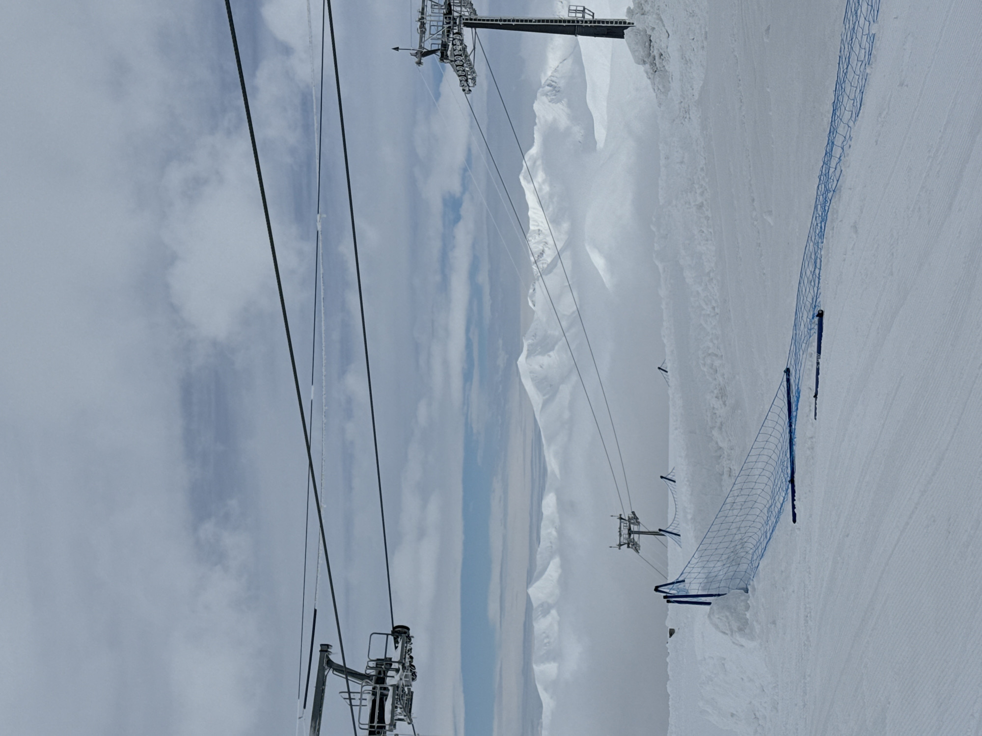 Gondola lifts operate at Gudauri ski resort during snowy morning