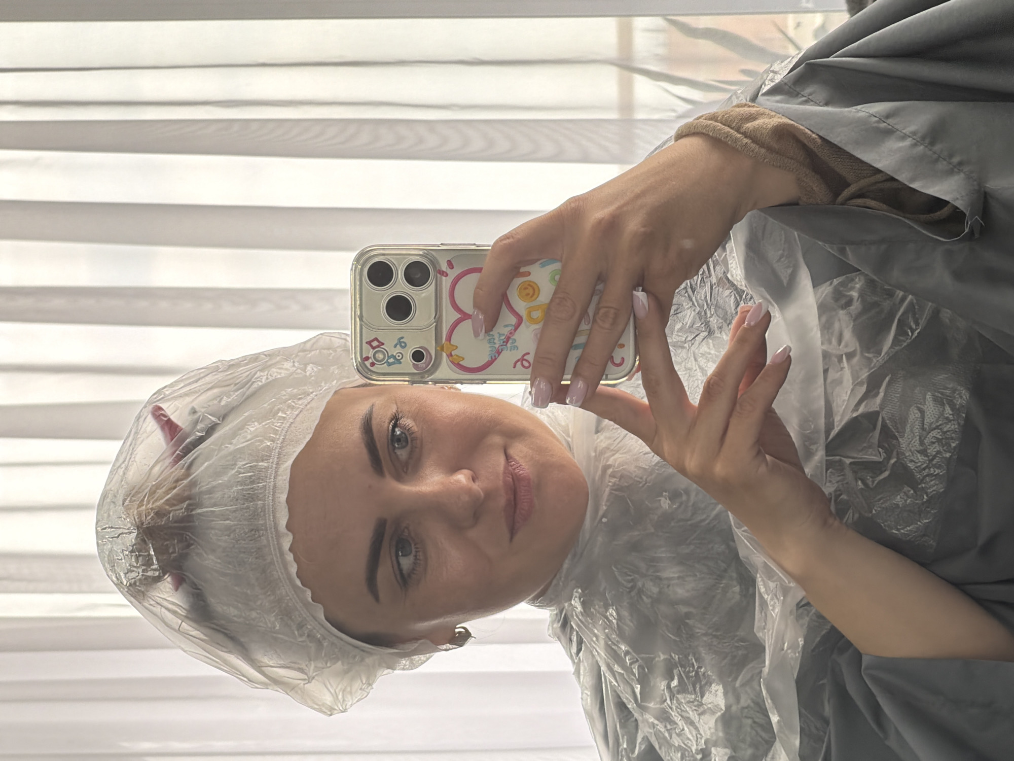 Woman takes salon selfies during hair treatment in Votkinsk
