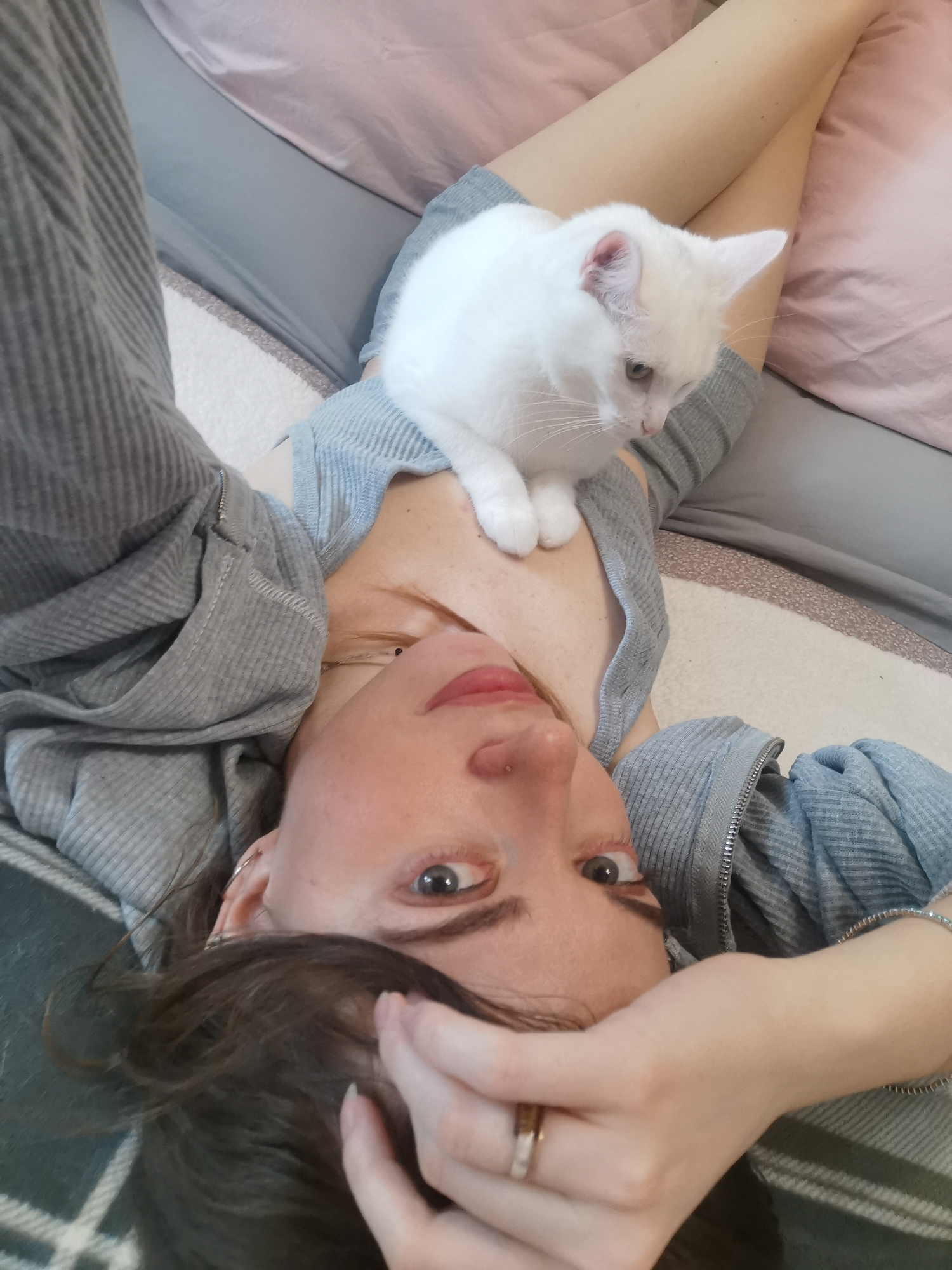 Woman and white cat share quiet indoor moments