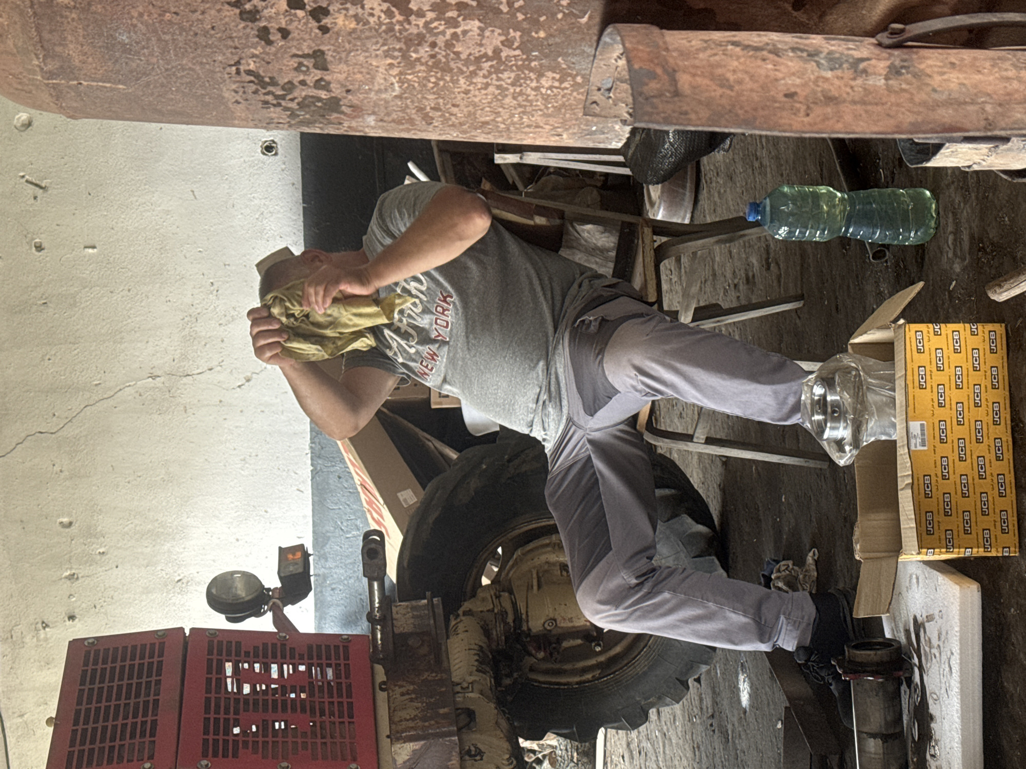 Early morning tractor repair session in Bulgarian village workshop