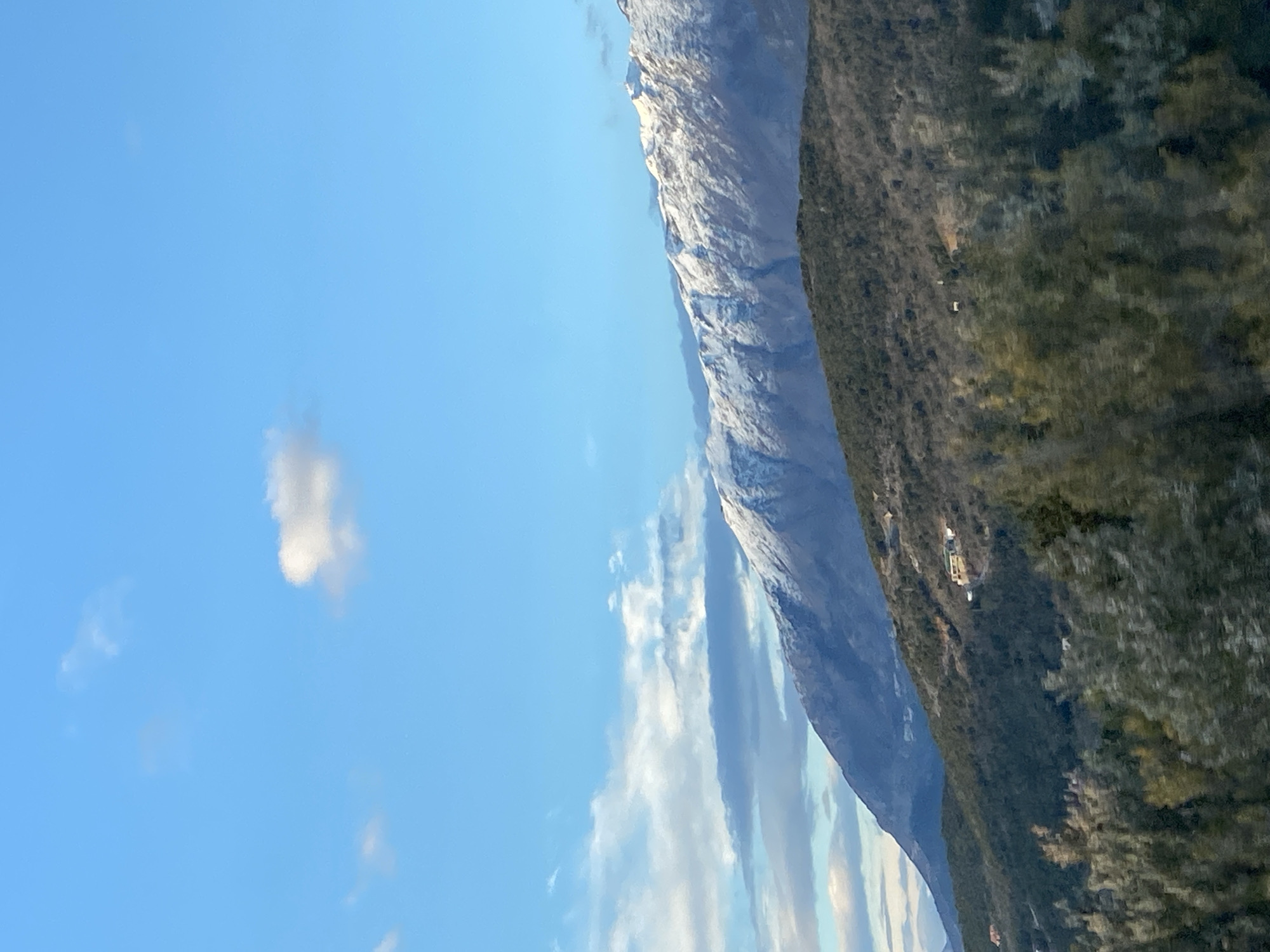 Snow-capped mountains viewed from vehicles in Montenegro countryside