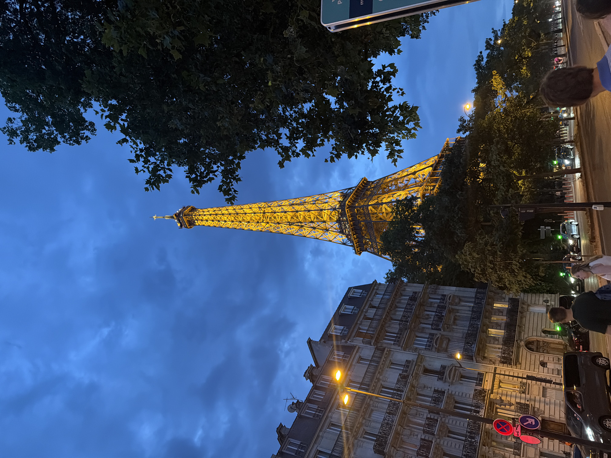 Eiffel Tower glowing at dusk, two angles