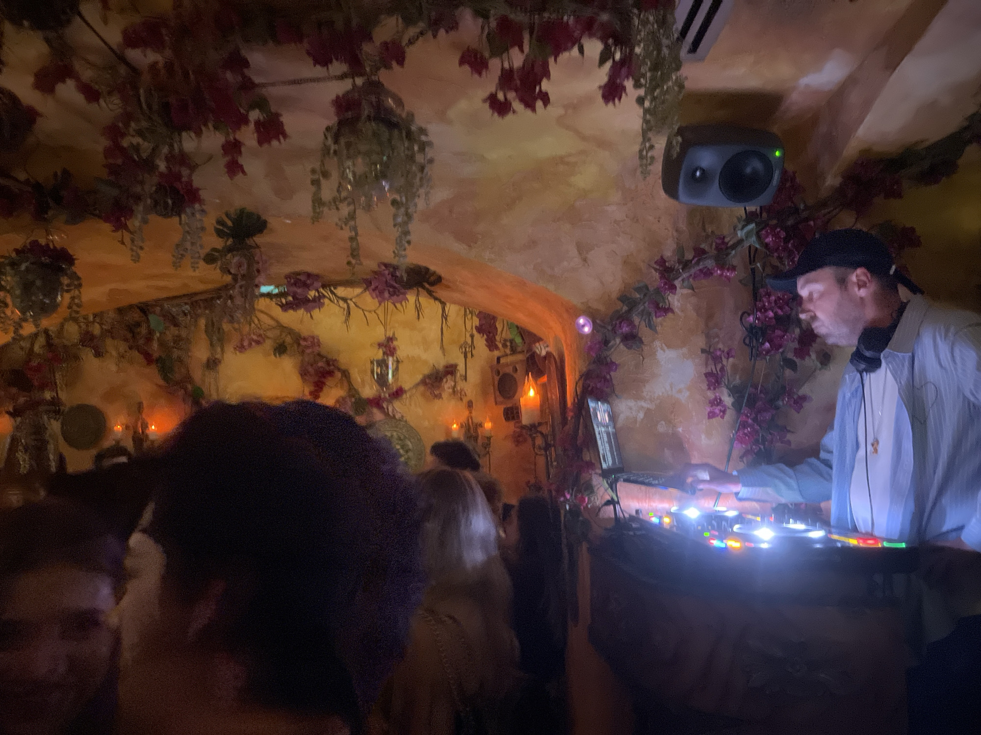Candlelit venue with DJ and crowd captured in Paris
