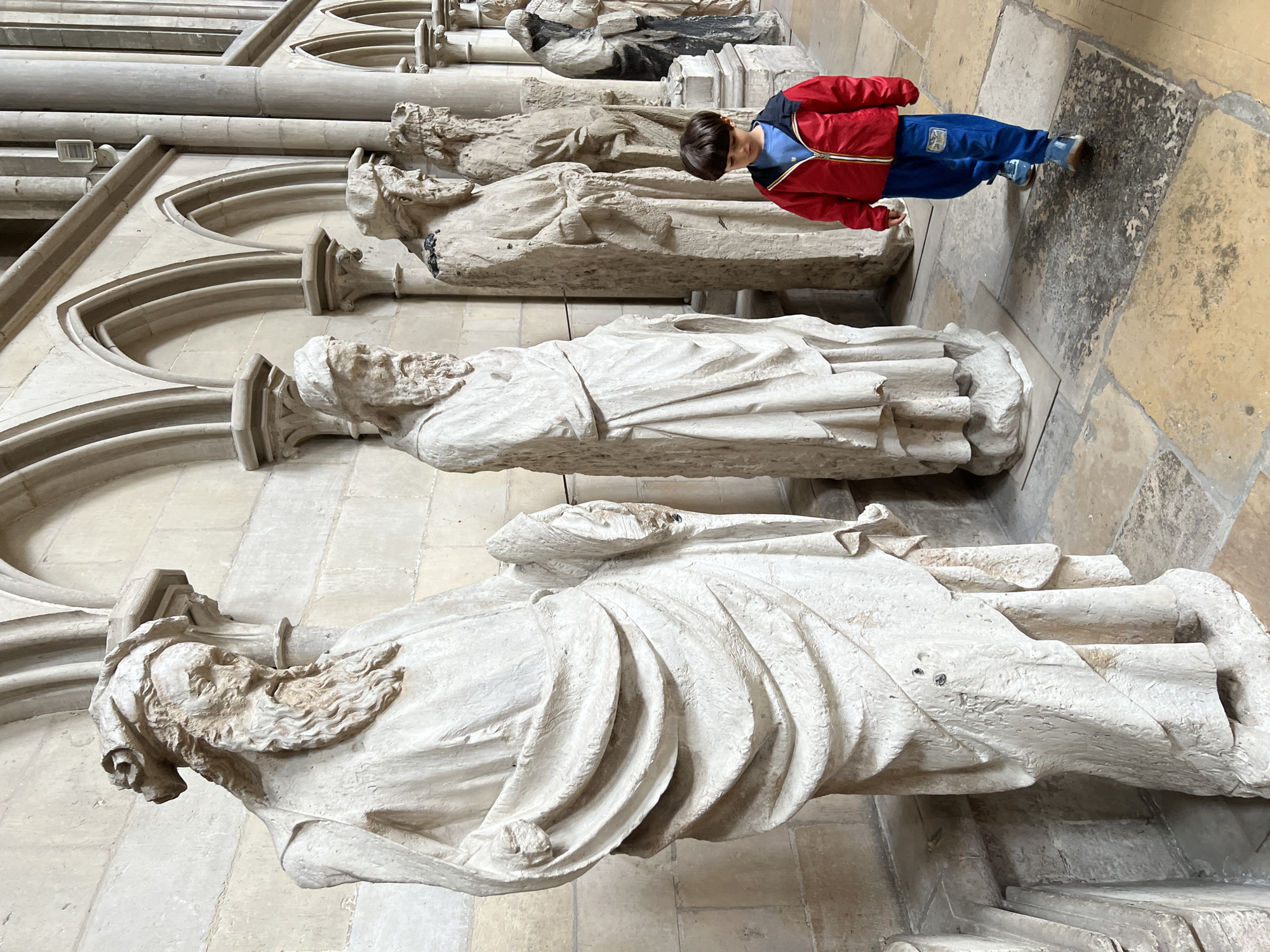 Boy in colorful jacket spotted inside historic stone cathedral