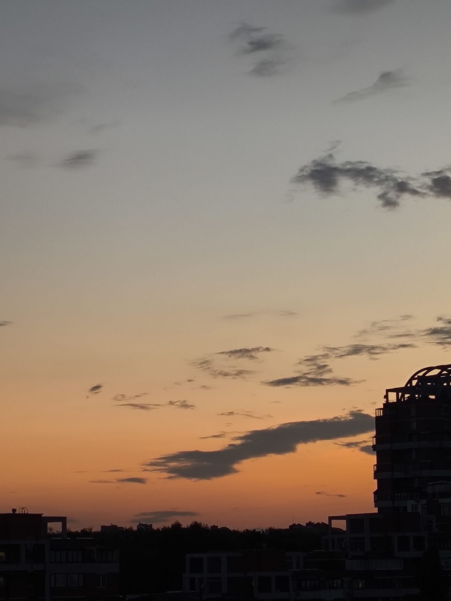 City sunset observed across urban landscape during evening hours