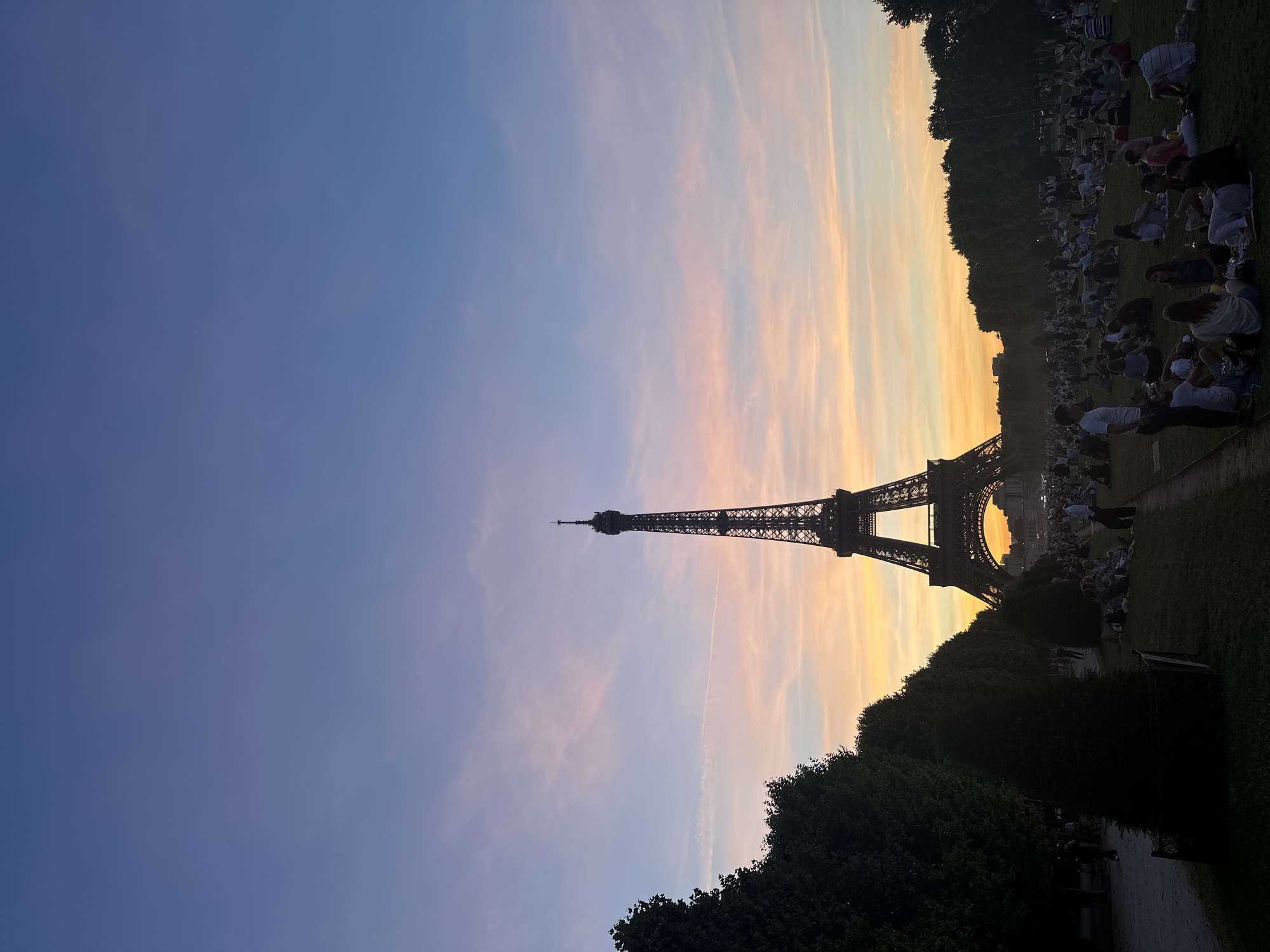 Eiffel Tower at sunset, crowds on the Champ de Mars