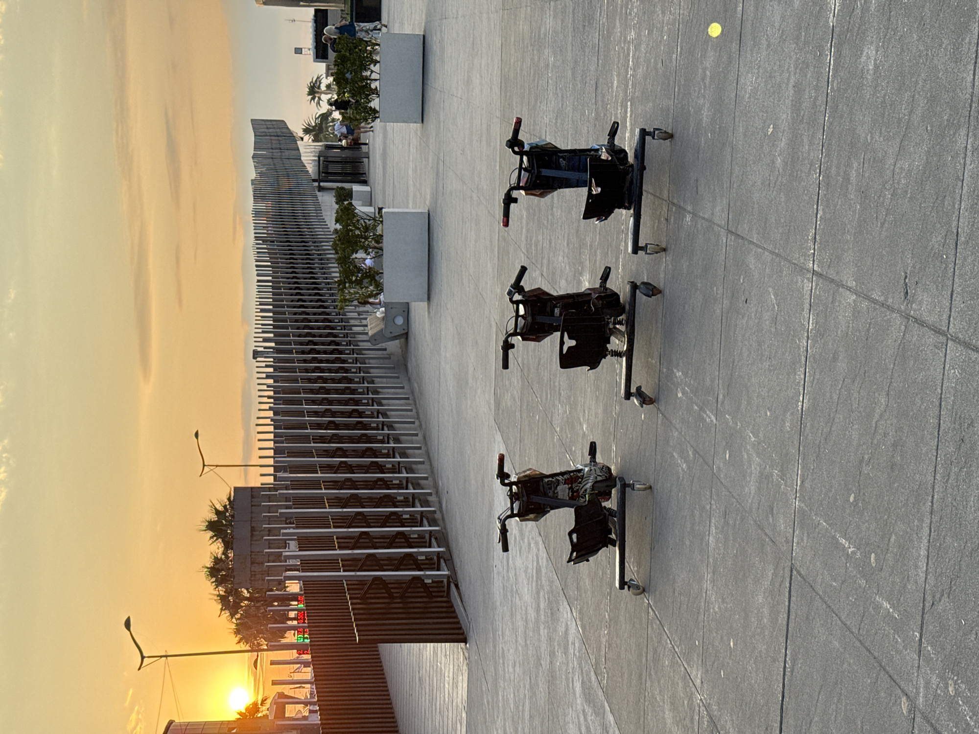 Drift trikes and fountains at a city plaza around sunset