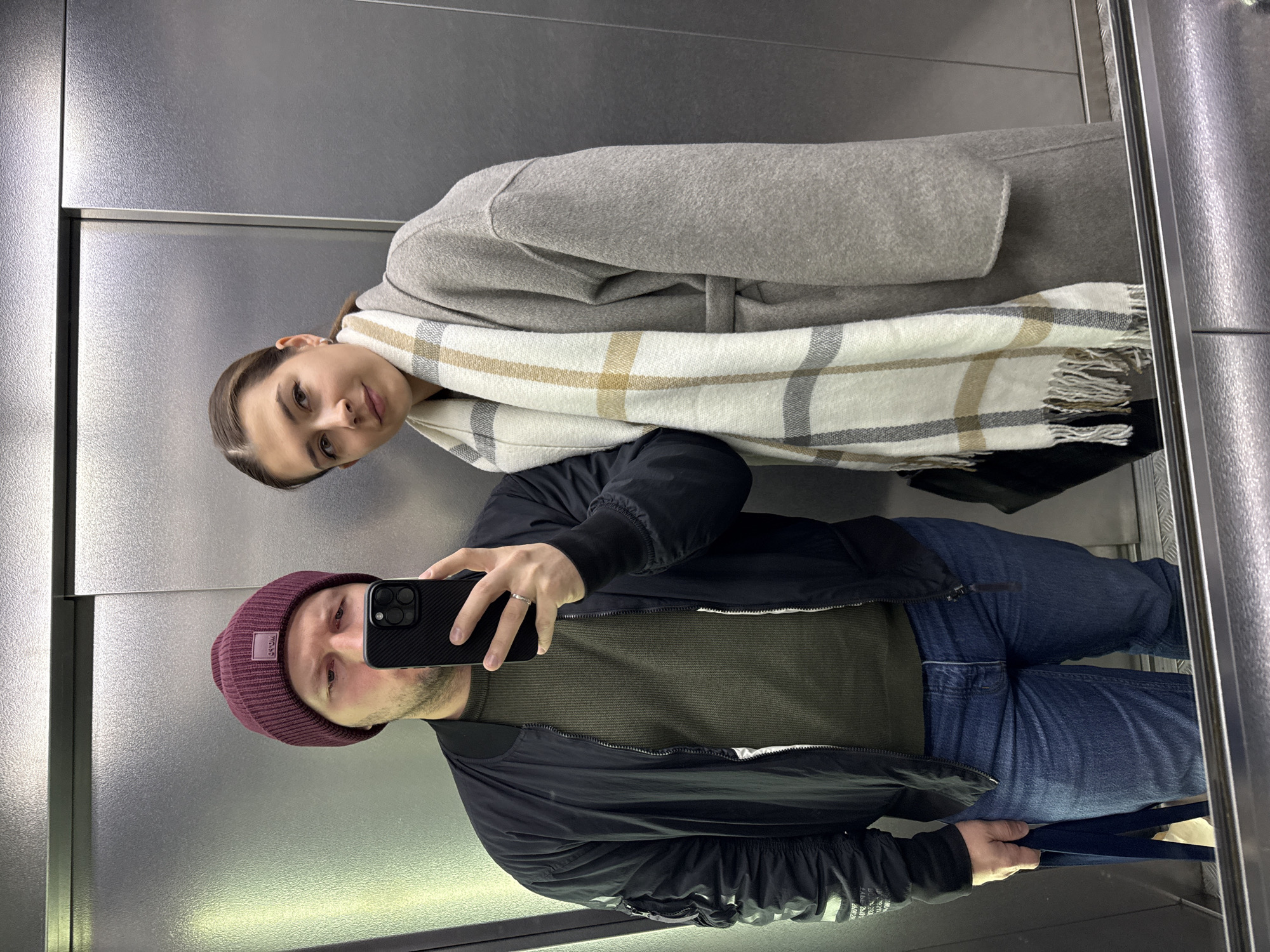 Two people caught in elevator reflection in Krasnoyarsk