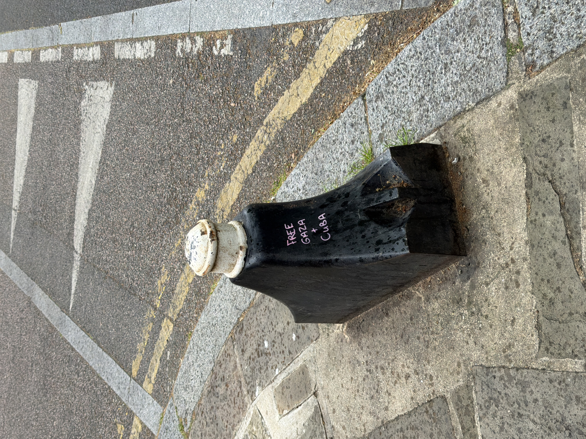 London street bollard with graffiti documented by witness