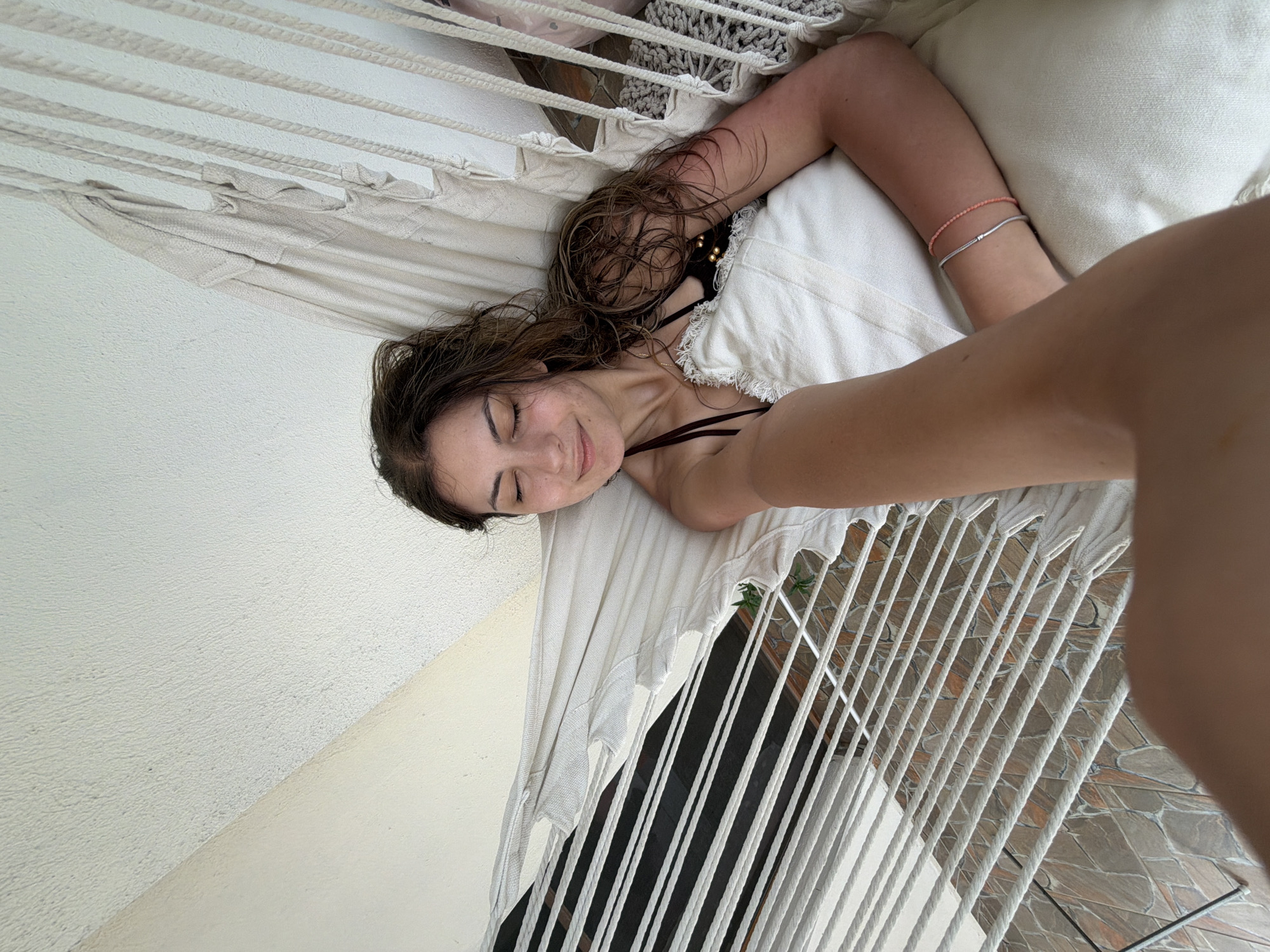 Woman relaxes in hammock on Bulgarian coastal balcony