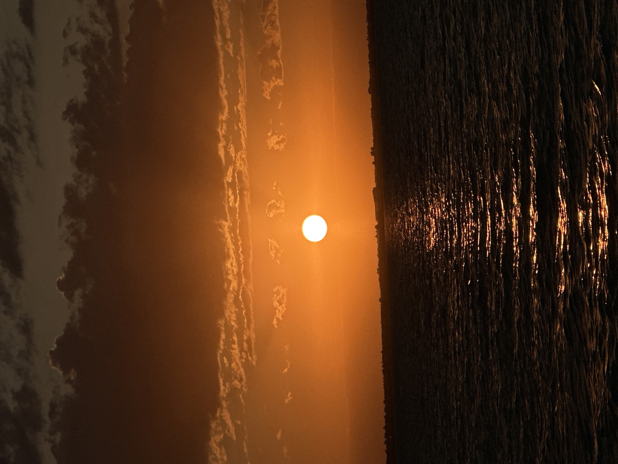 Vivid orange sunset over a Kokshetau waterway