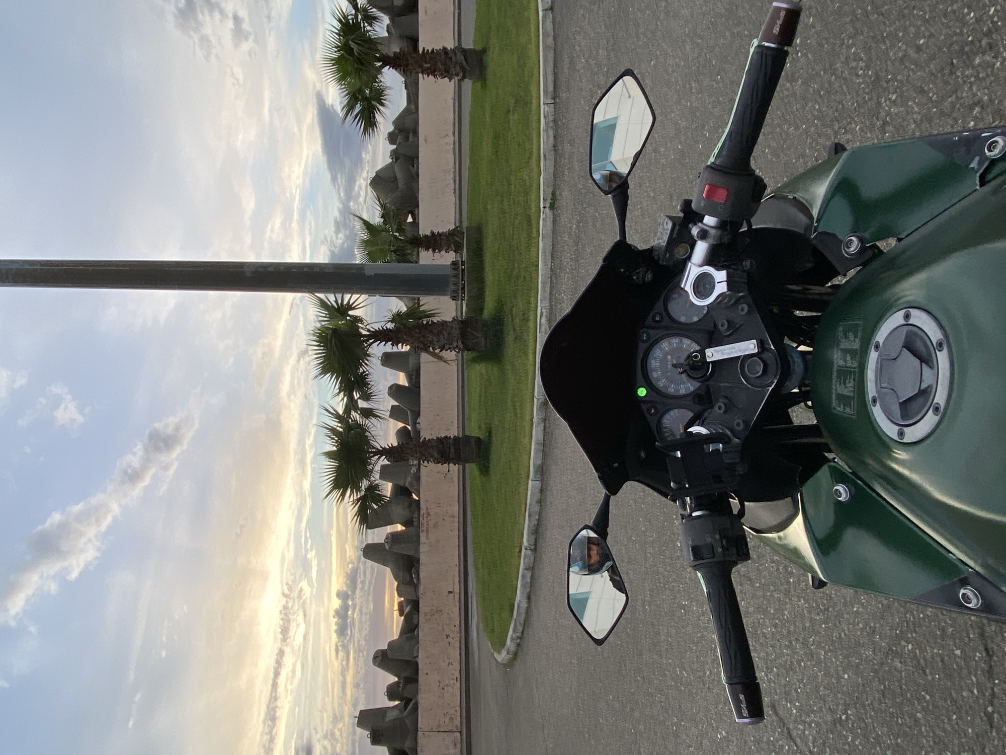 Motorcyclist on green Kawasaki Ninja parked in Sochi