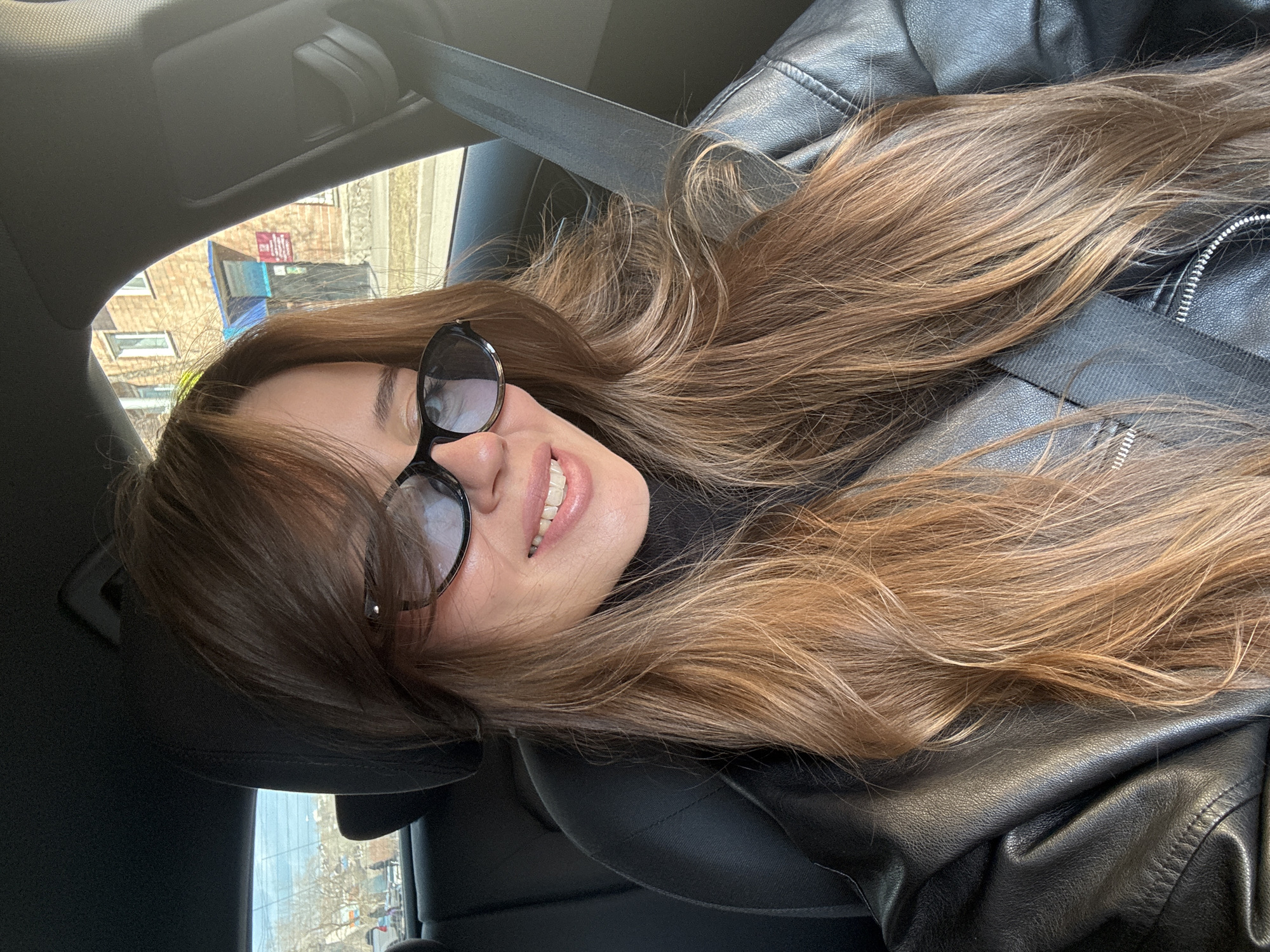Person in leather jacket photographed in car, Krasnoyarsk