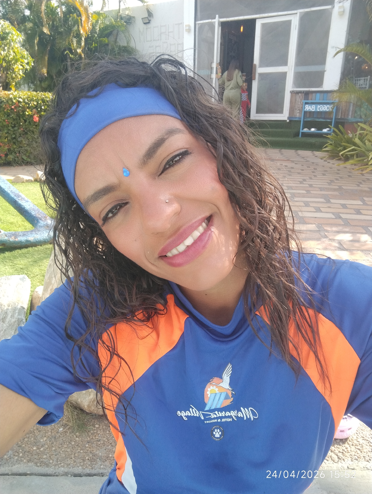 Woman takes selfie outdoors wearing logo shirt