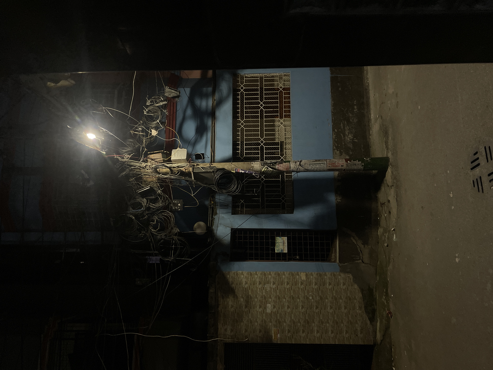 Nighttime street scenes documented in Dhaka alleyways