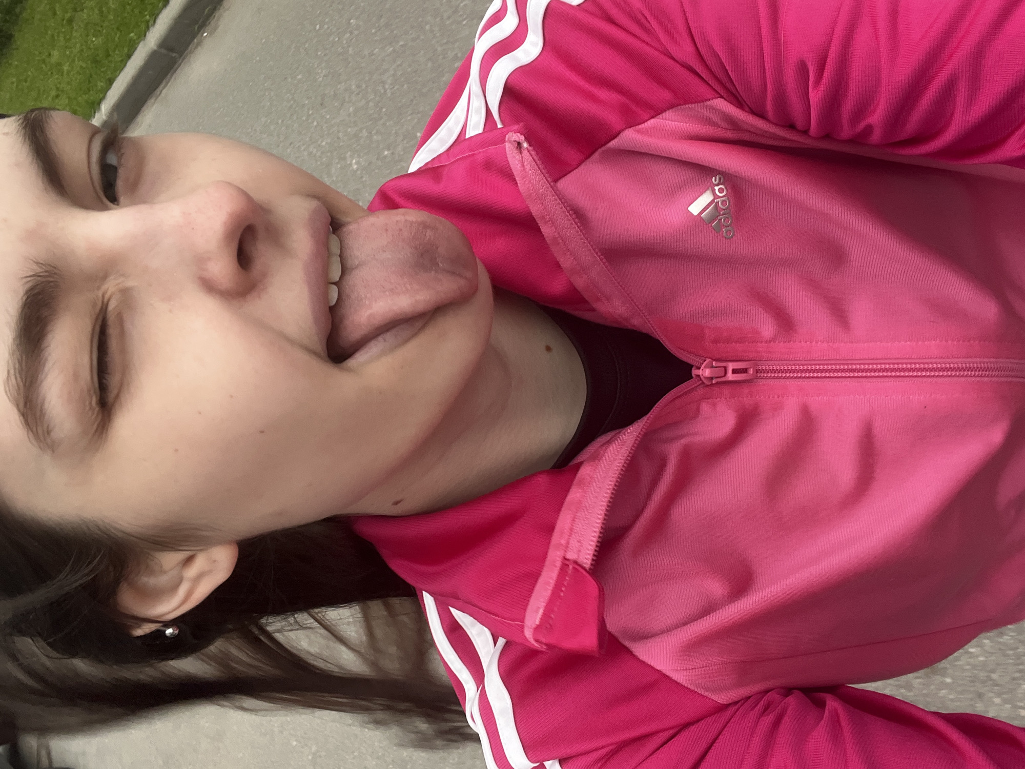 Woman in pink Adidas tracksuit takes selfies around Saint Petersburg