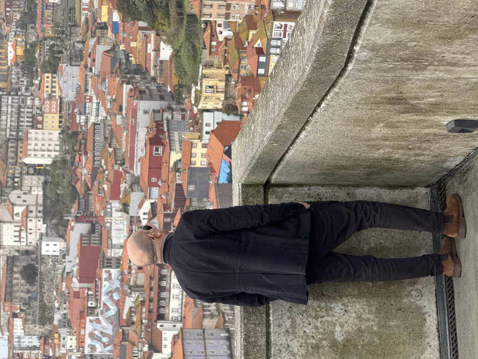 Man views Porto cityscape from Vila Nova de Gaia platform