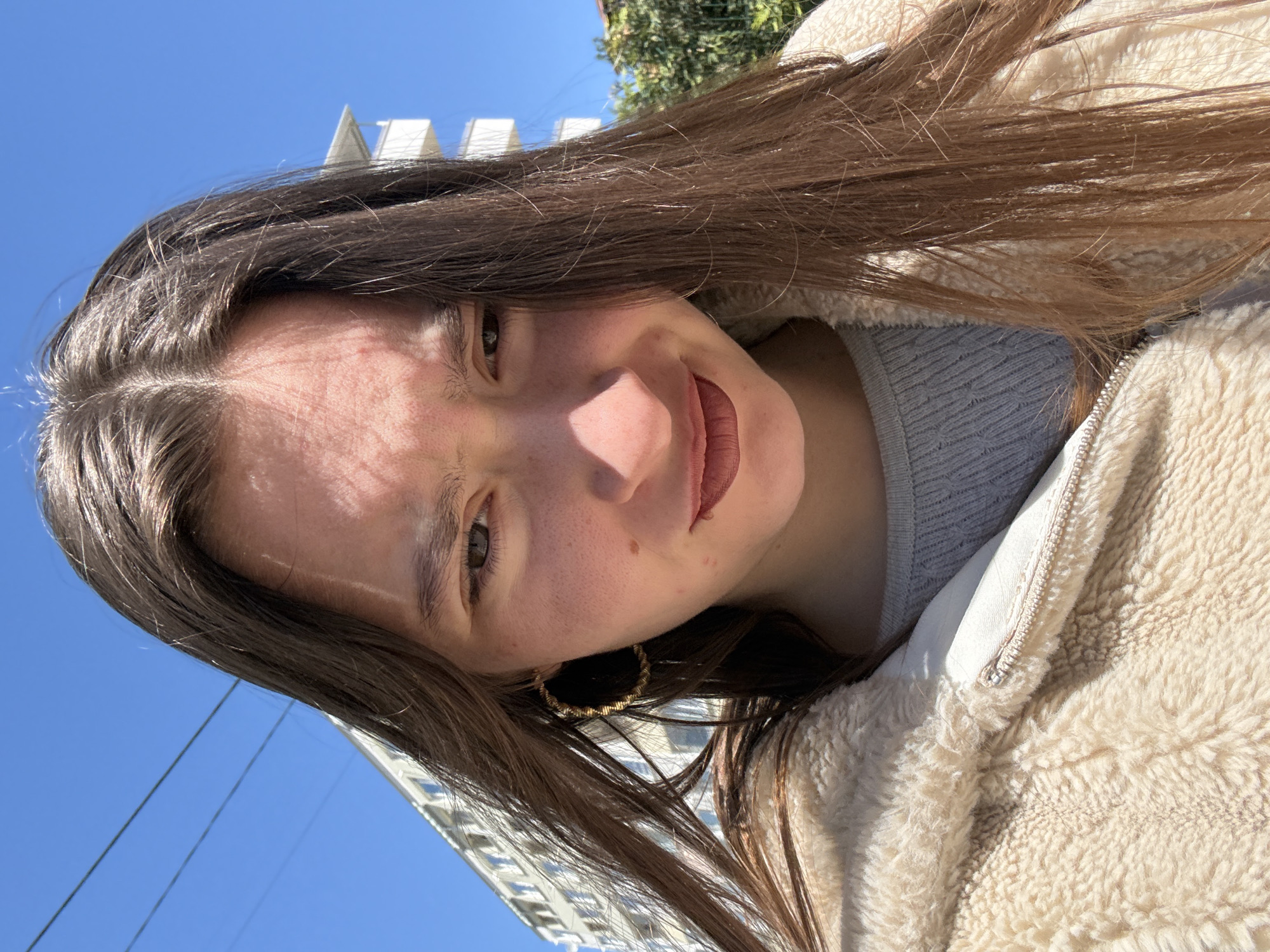 Woman takes selfies on sunny Sofia street