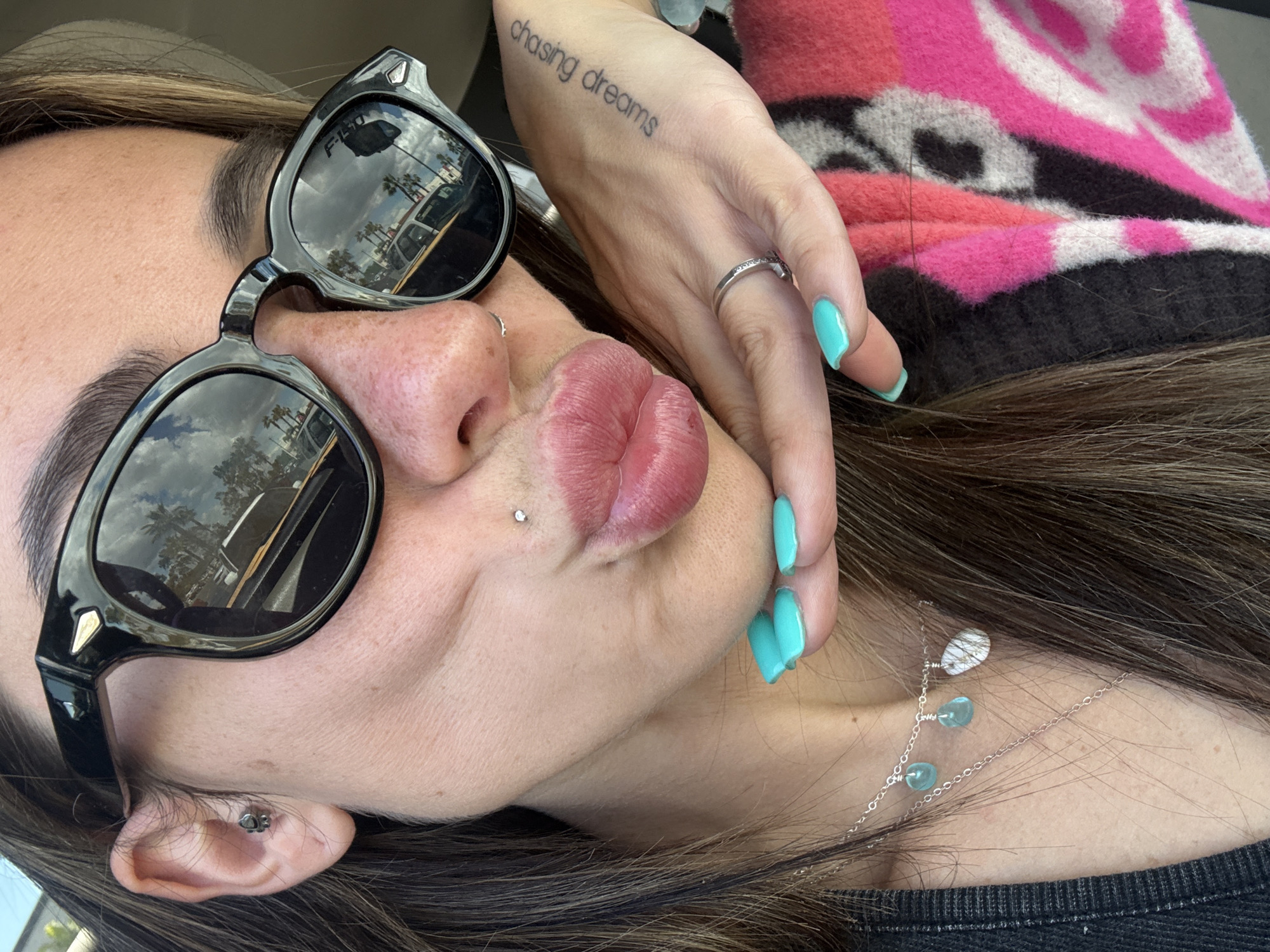 Person photographed with dreams tattoo in sunny Long Beach