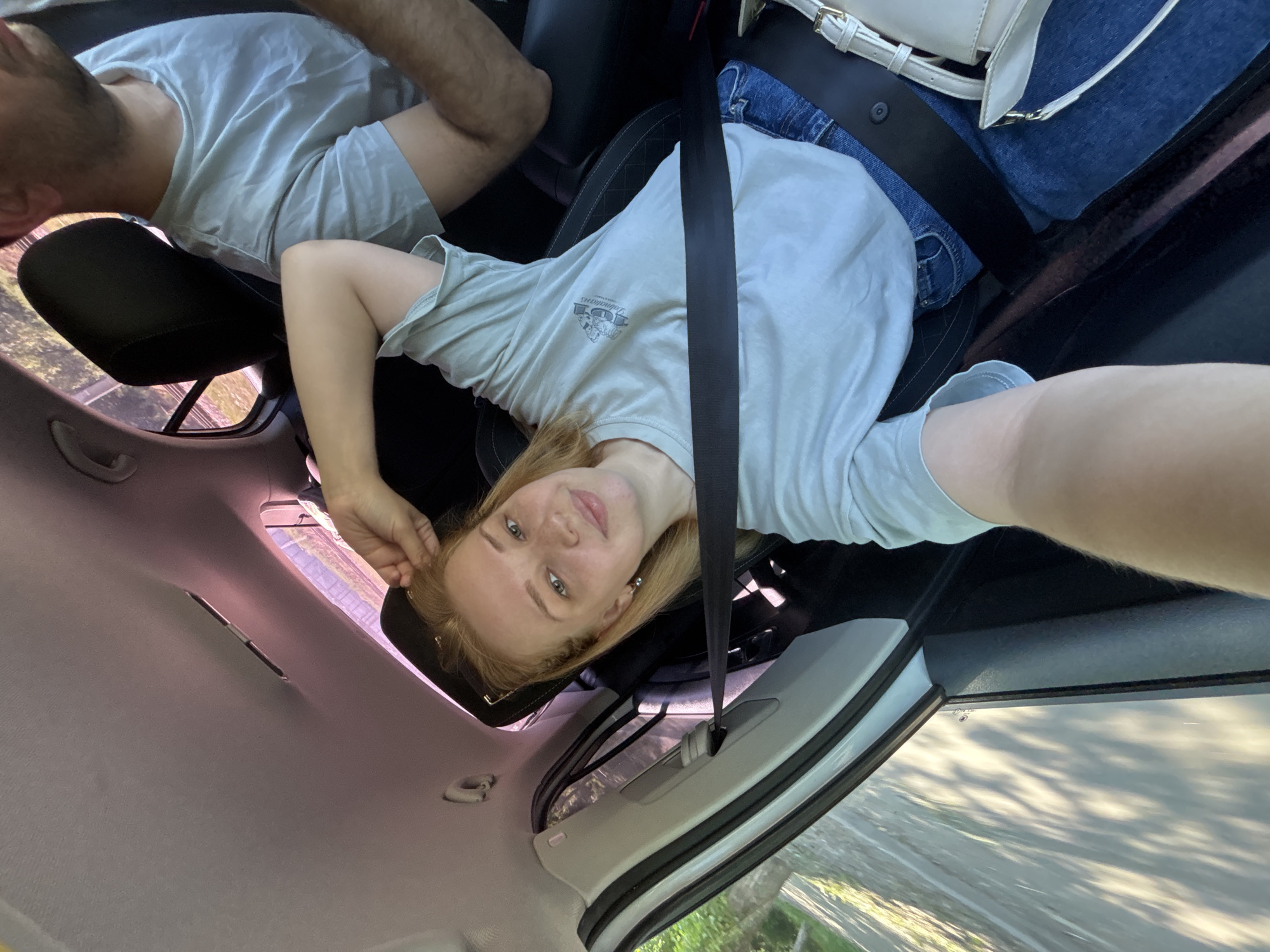Woman takes selfie in backseat during car ride in Yaroslavl