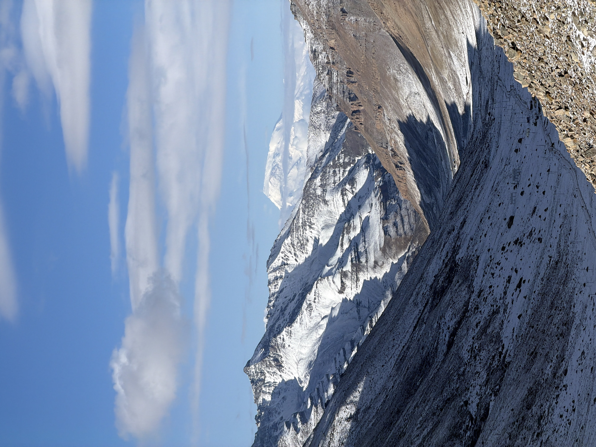 Snow-covered mountain peaks observed under clear skies in China