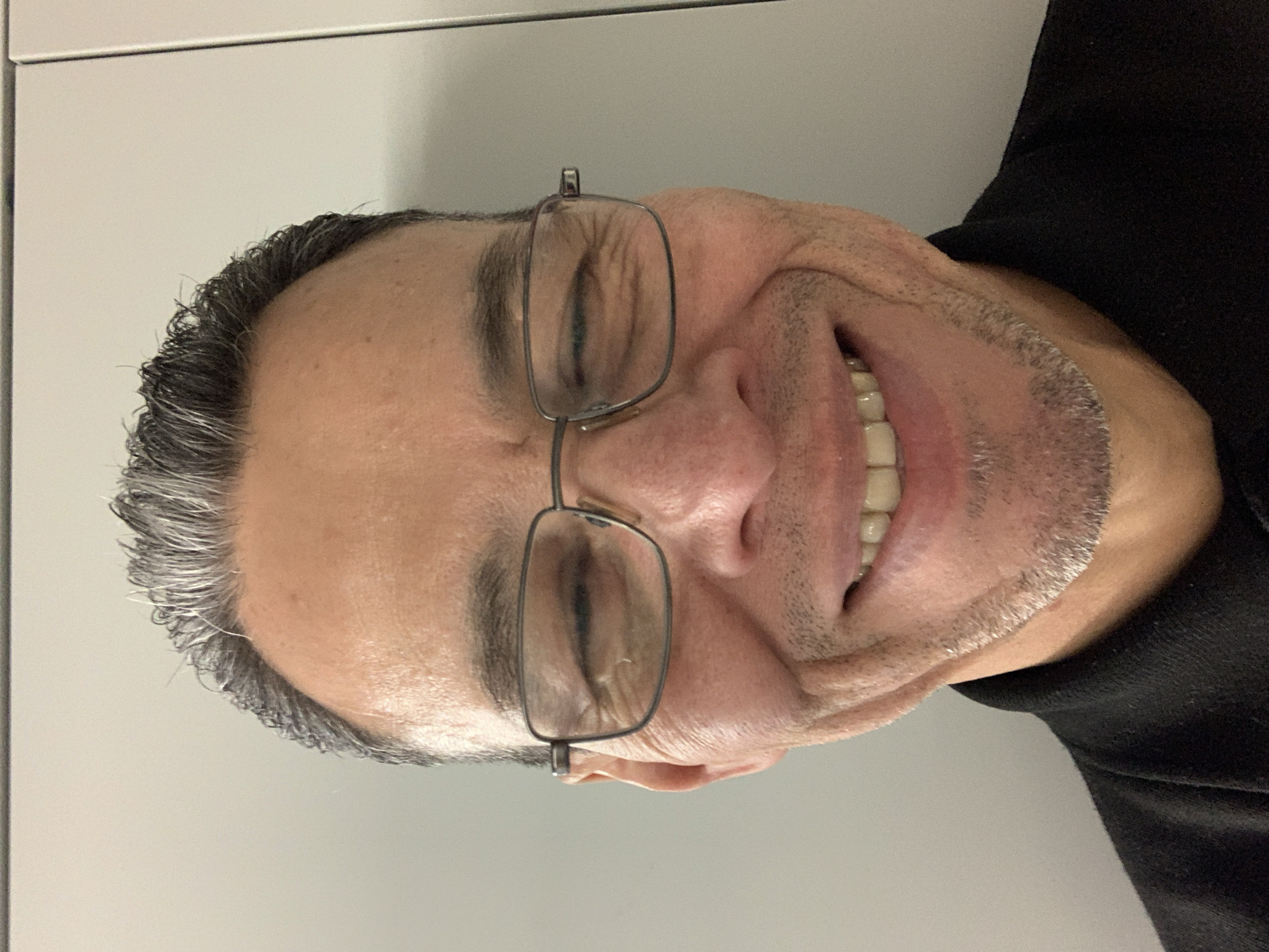 London resident photographed smiling with eyes closed indoors