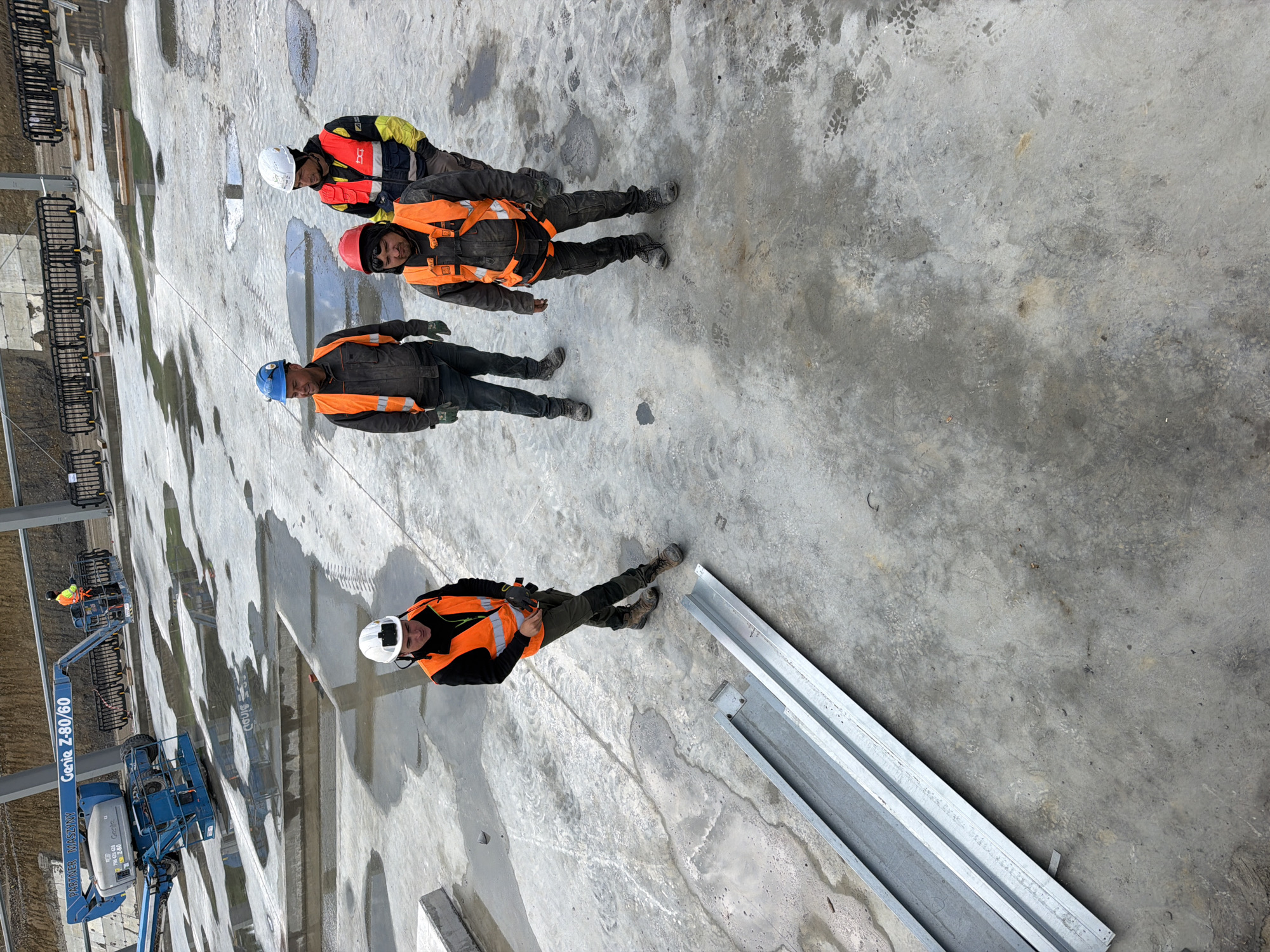 Construction workers active at steel beam site in Stróża, Poland
