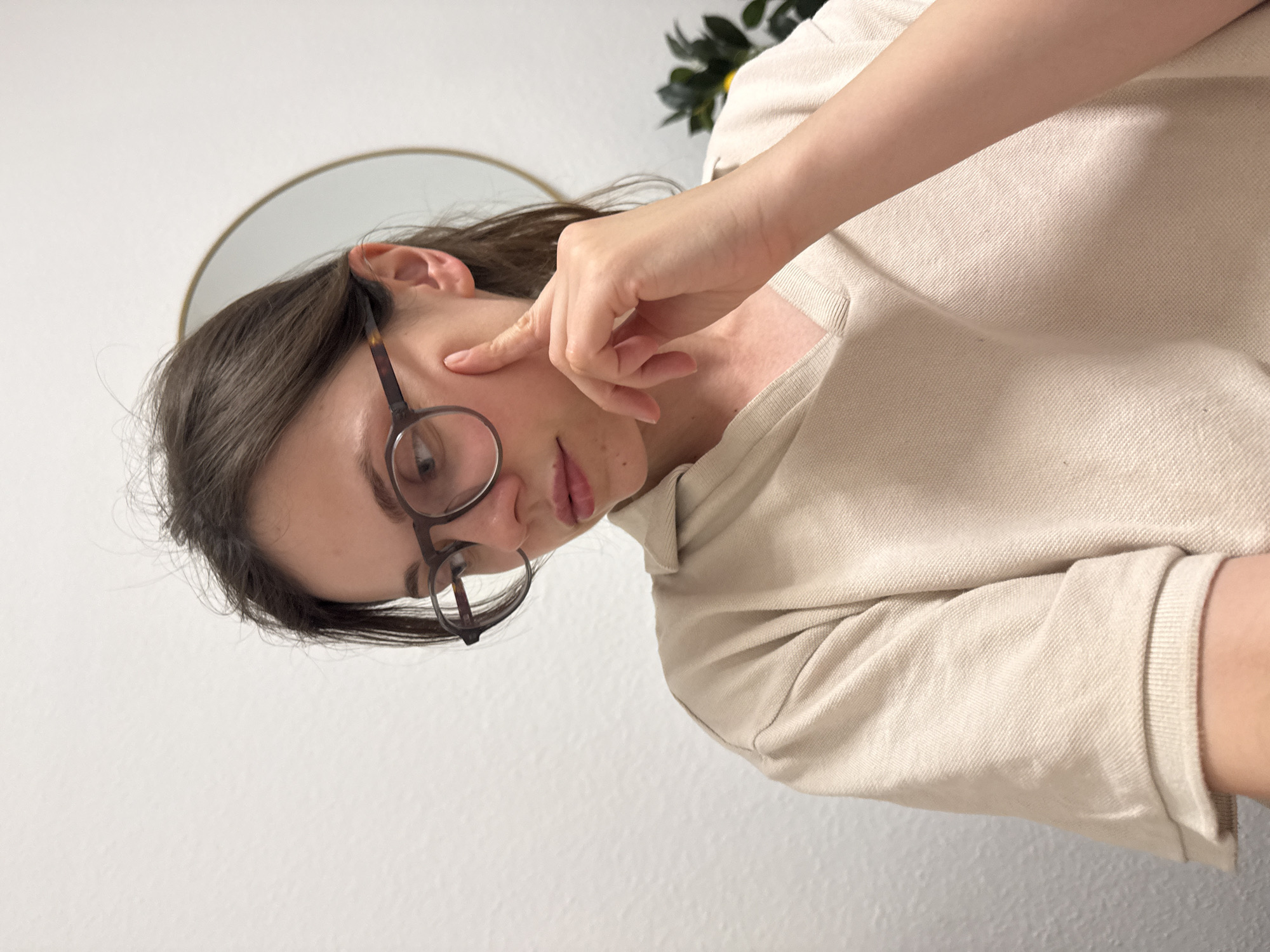 Woman touches cheek indoors in Kőröshegy, Hungary