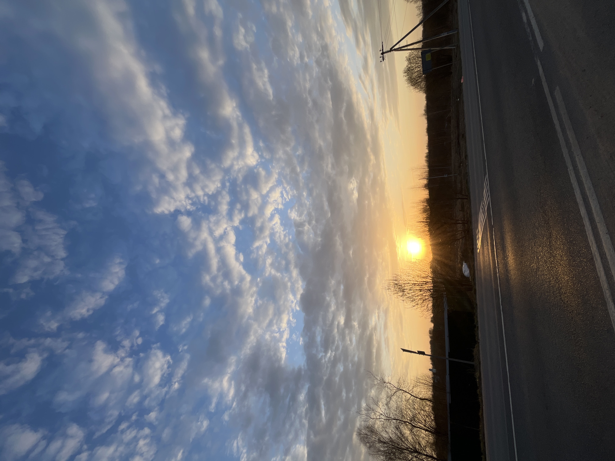 Woman captures sunset views during rural road journey in Russia