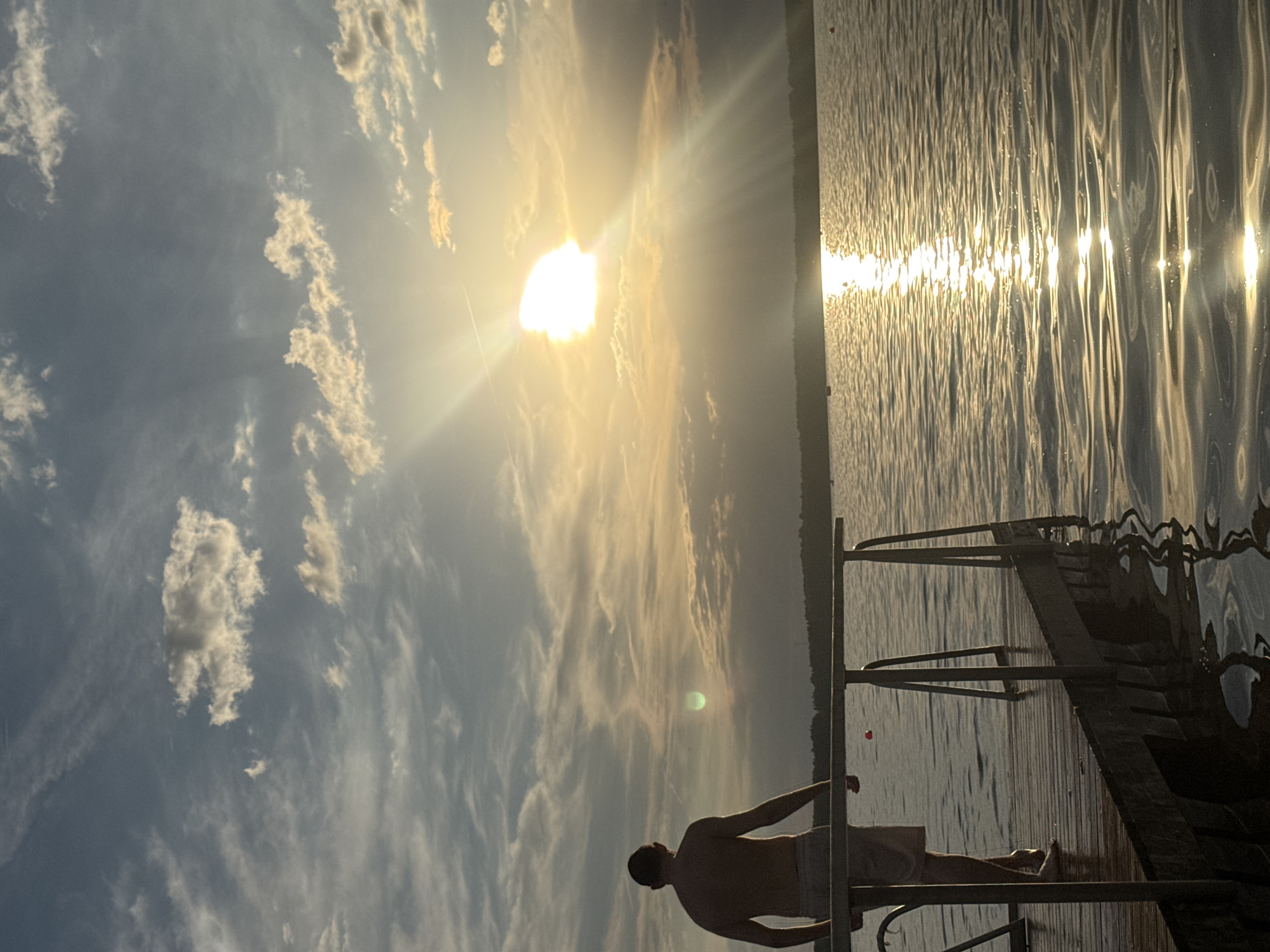 Sunset watchers gather on Tallinn waterfront during golden hour