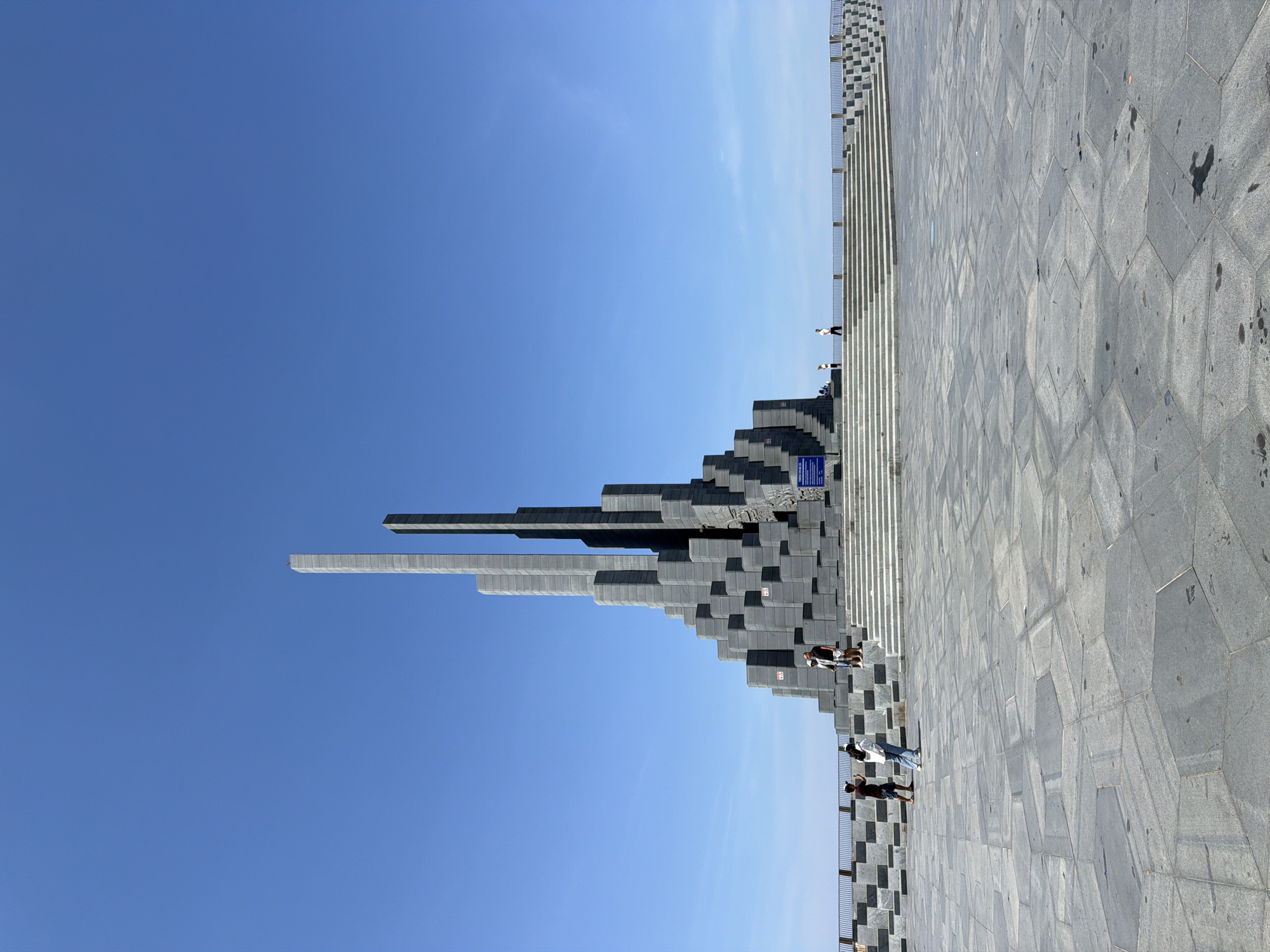 Martyr monument in Tuy Hoa, dark stone rising against blue sky