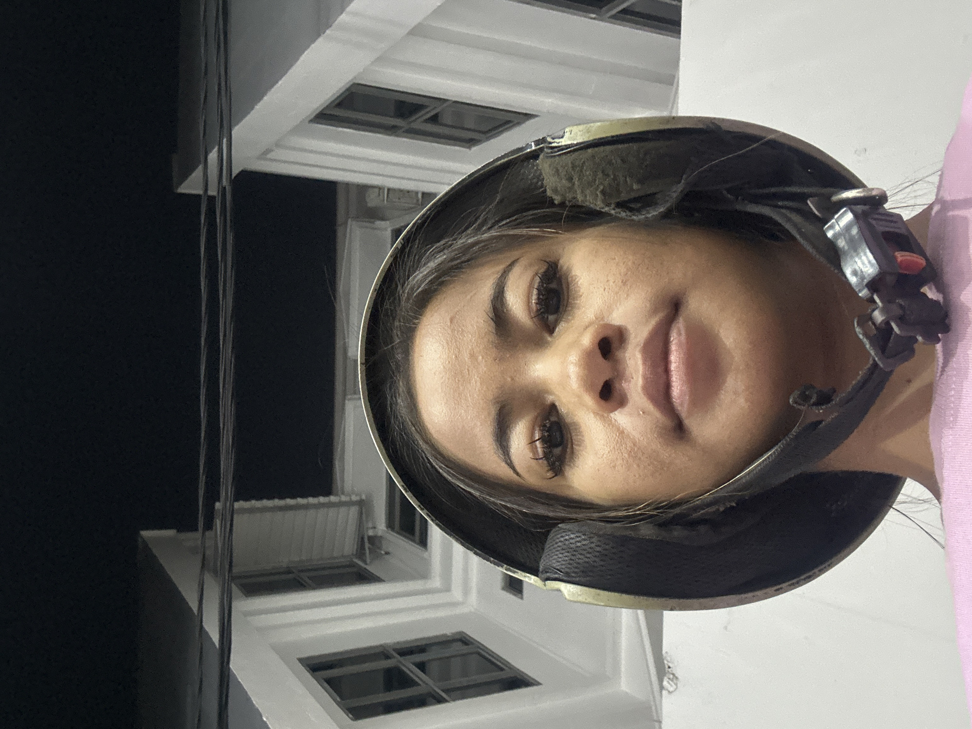 Woman in helmet photographed at Jakarta gas station
