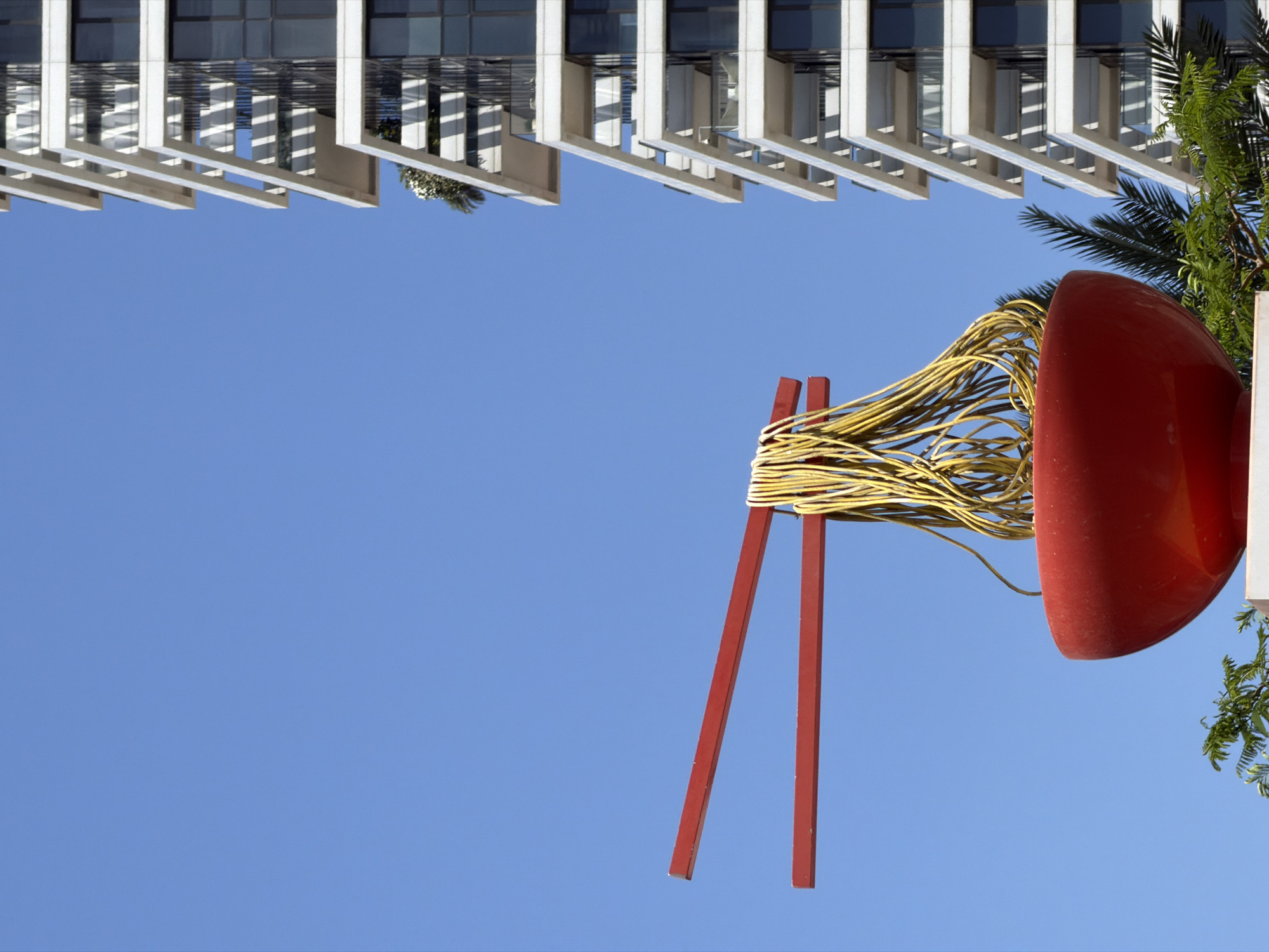 Morning scenes captured around red sculpture and skateboarder in Tel Aviv