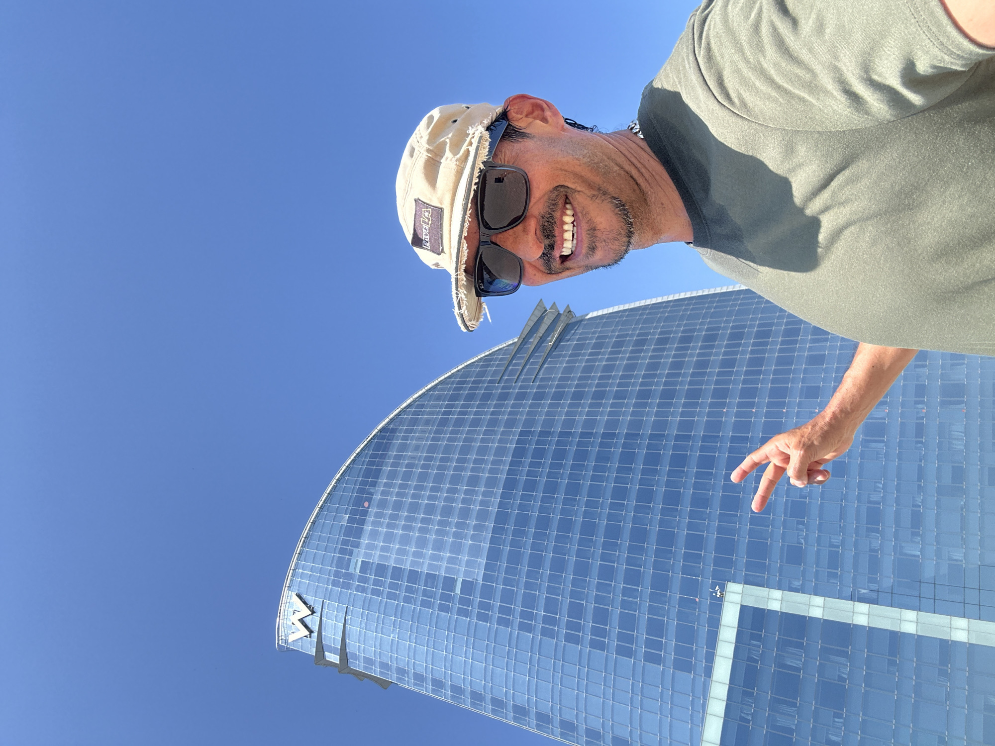 Tourist photographs himself at Barcelona's Barceloneta Beach near W Hotel