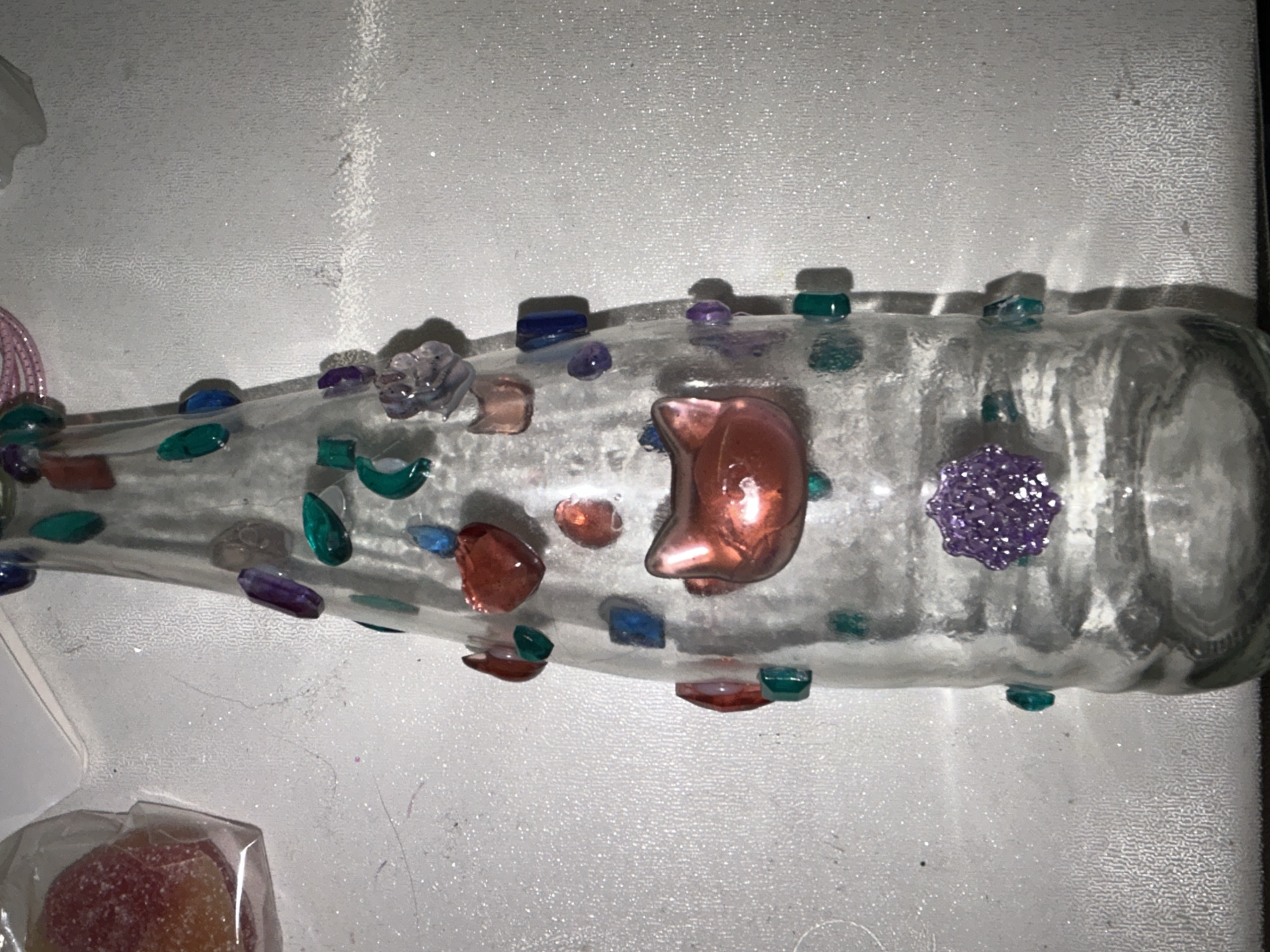 Colorful gems, vials, and hair ties in a crafting spread
