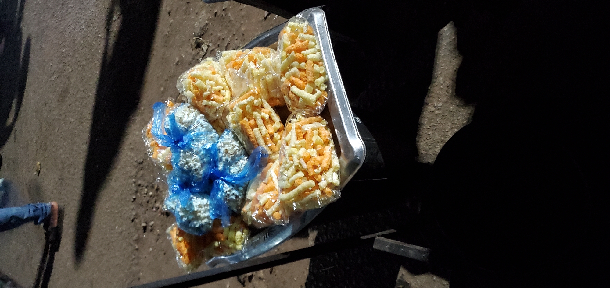 Night street food vendors serve snacks and fruit