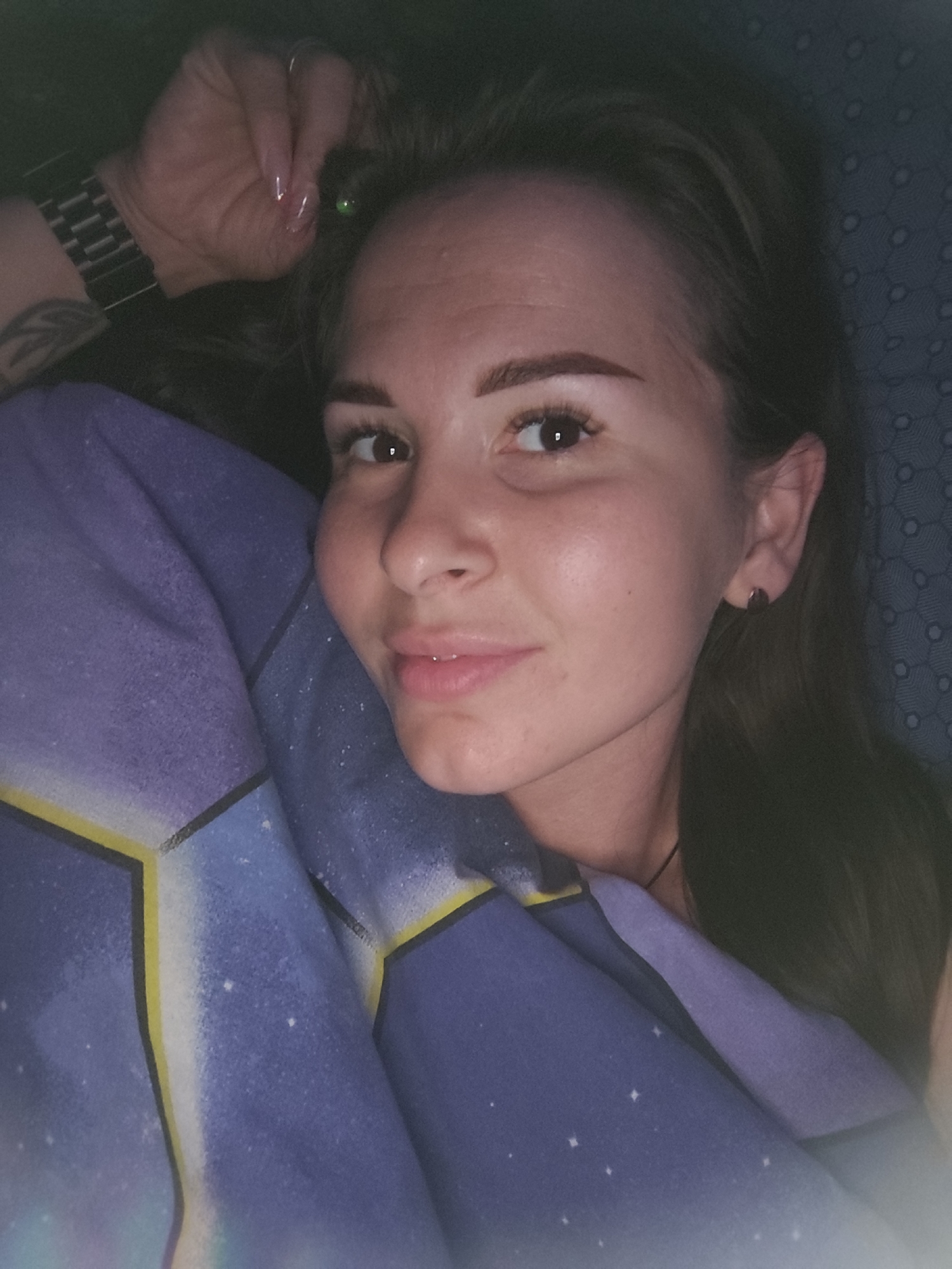 Resting in bed, blanket up, silver watch and pale pink nails