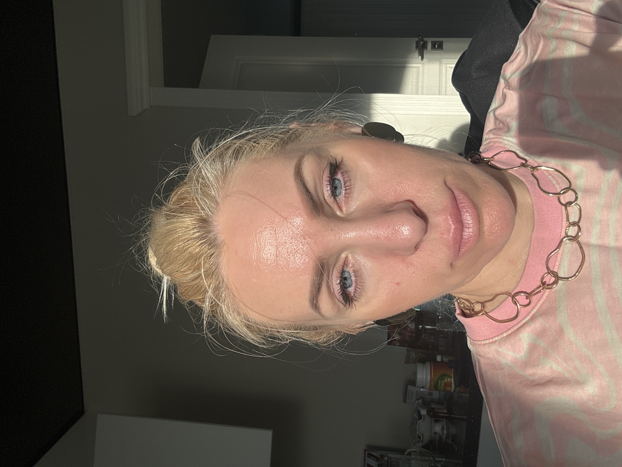 Woman eats yogurt in kitchen during afternoon snack time
