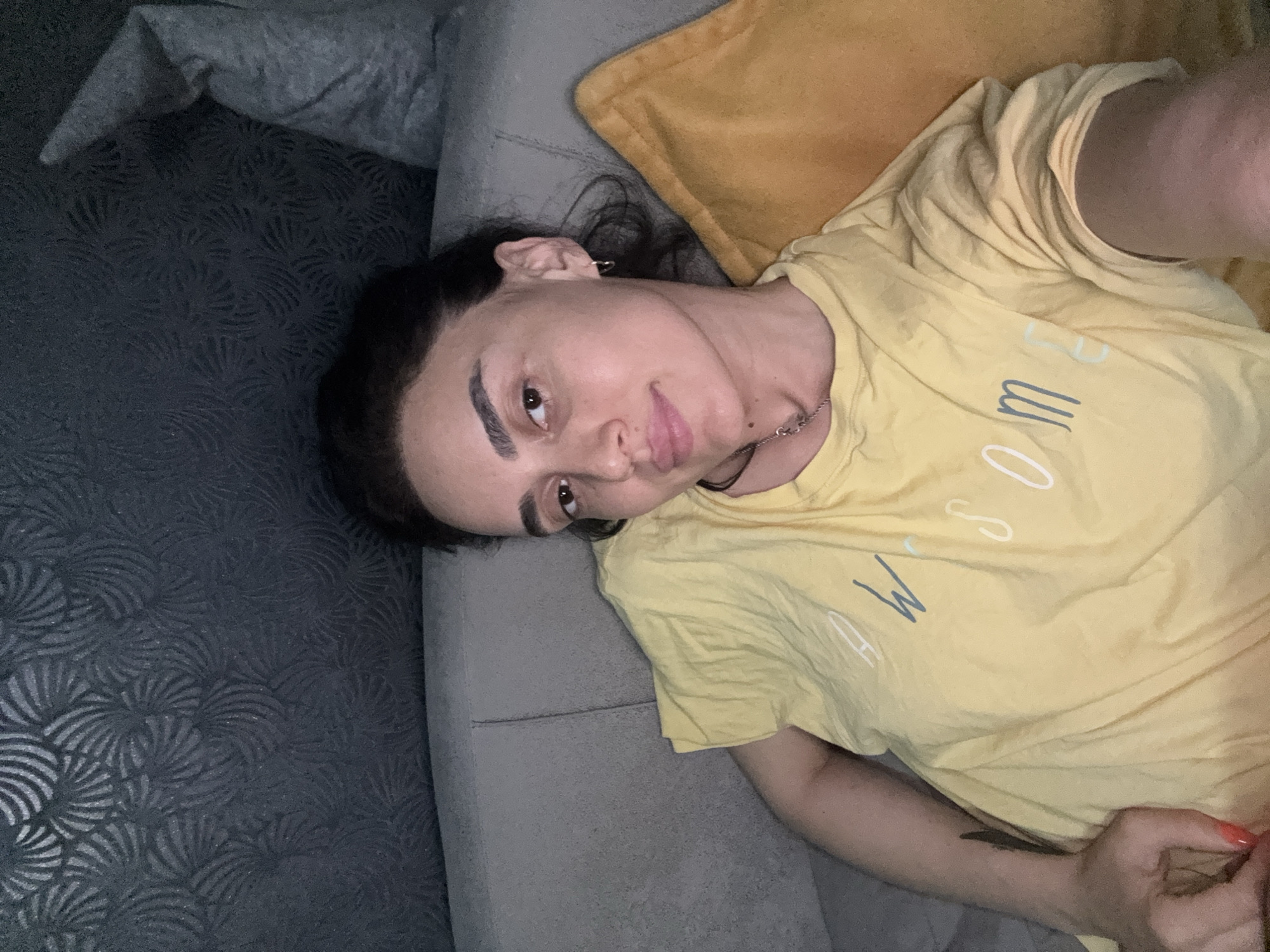 Woman relaxes on sofa in Tbilisi apartment