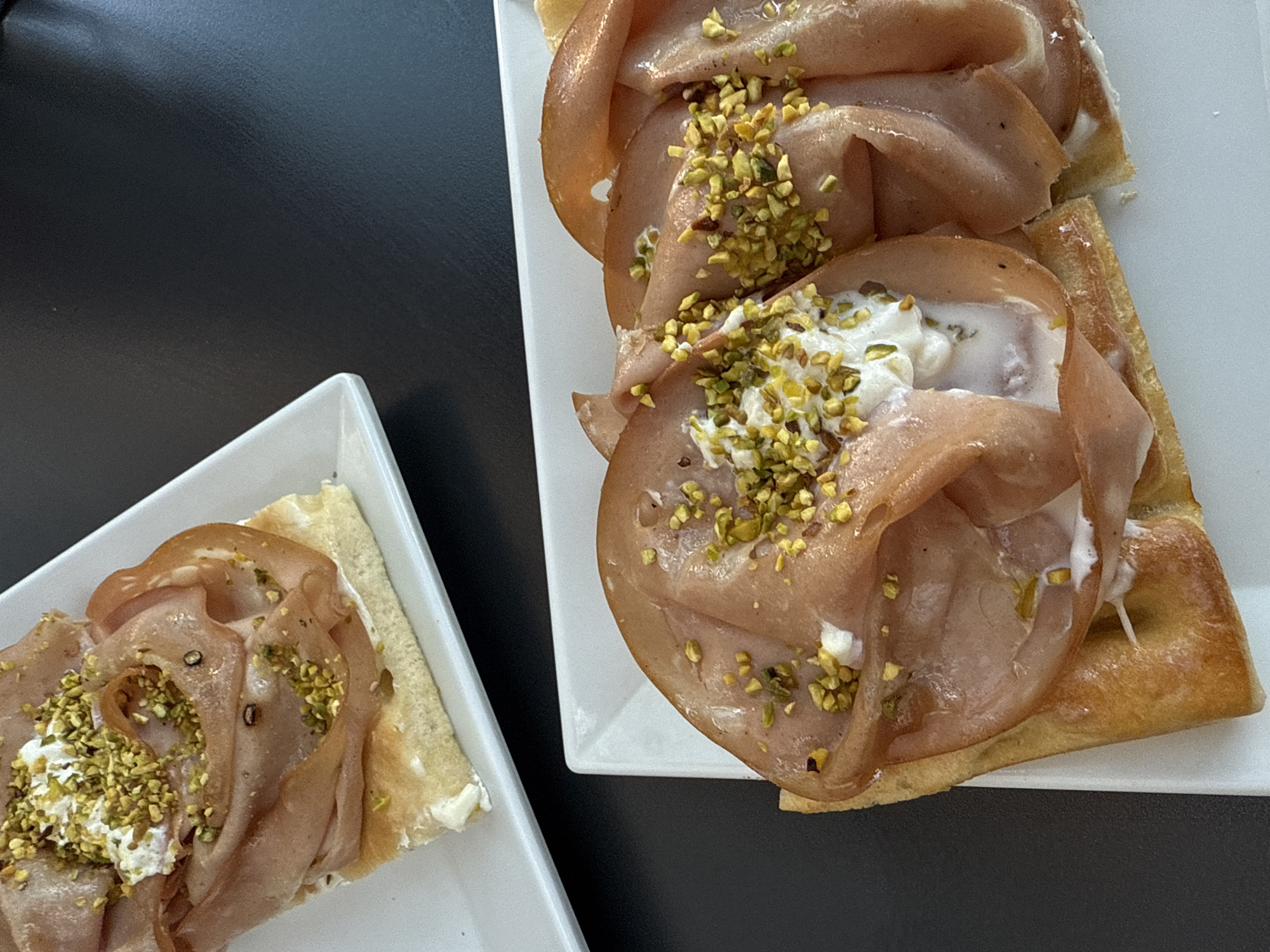 Open-faced sandwiches photographed on white plates in Milan