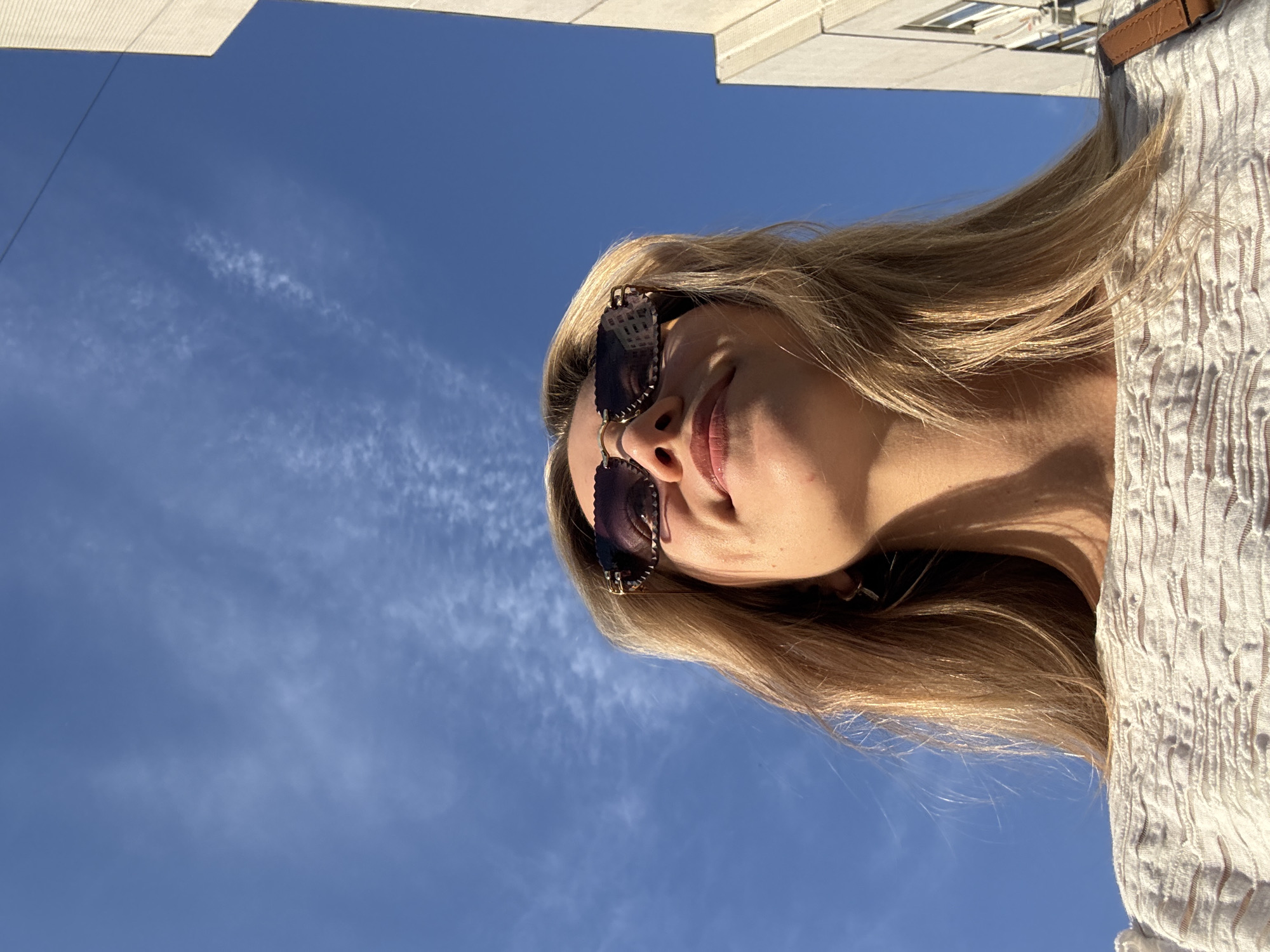 Woman documents urban afternoon with selfies and street walking