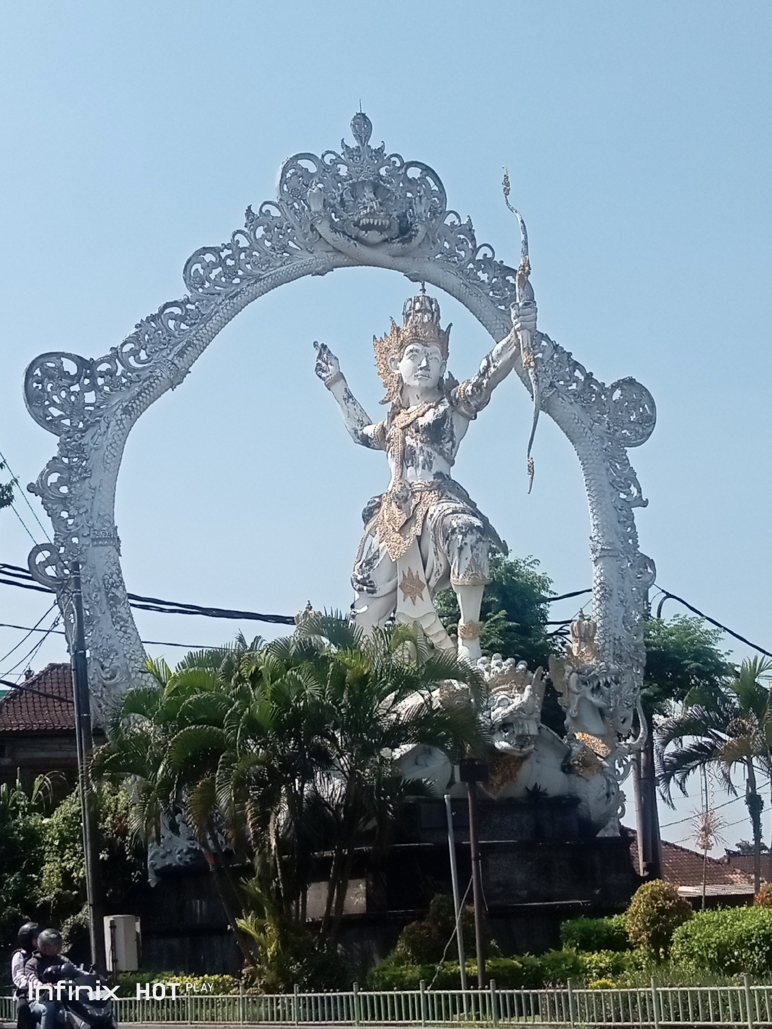 Ornate crowned statue with bow and arrow in Gianyar