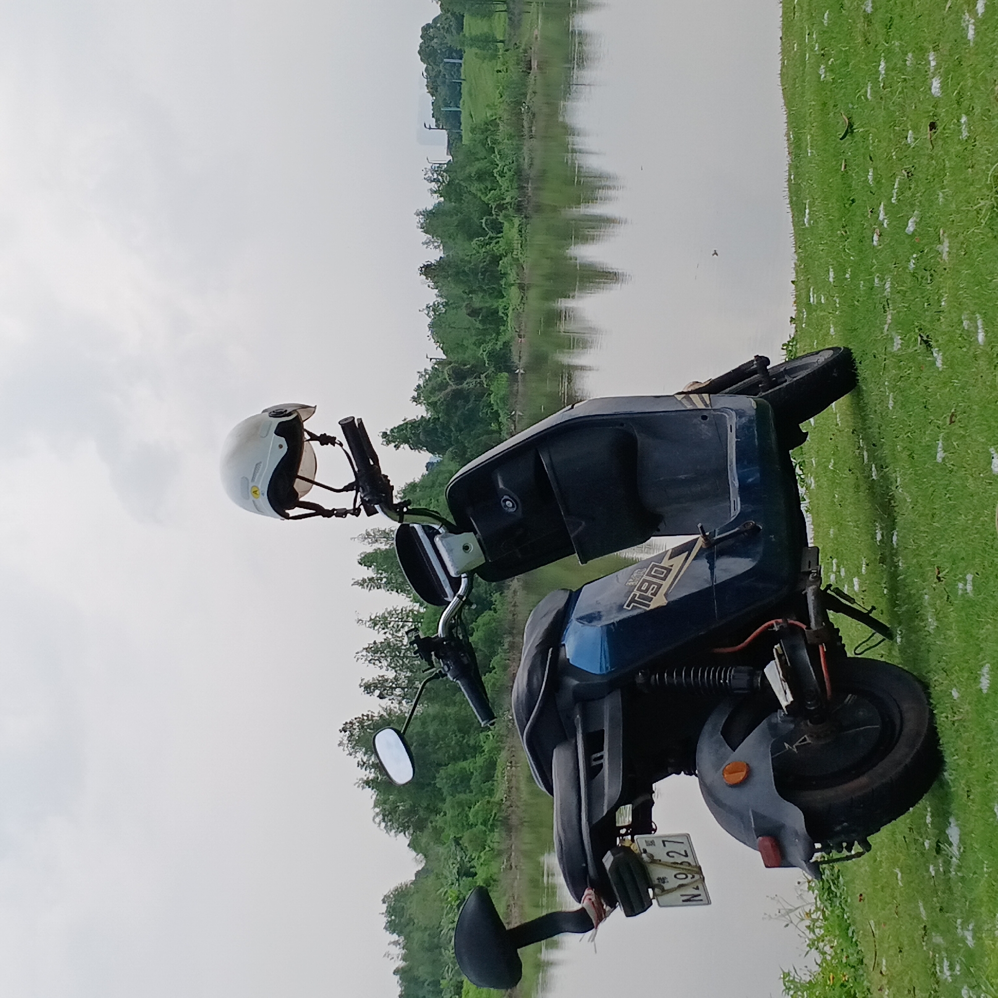 Quiet lakeside moment captured with electric scooter in Shunde
